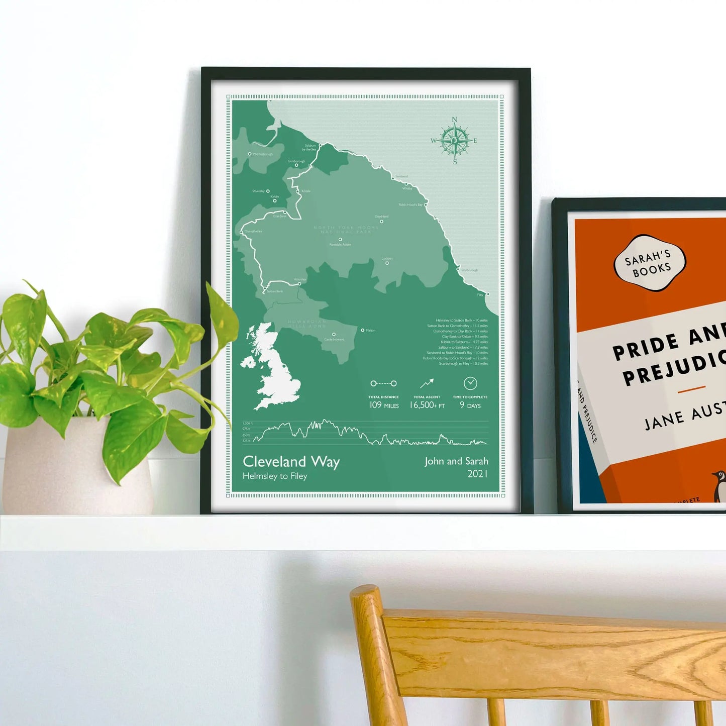 Framed print on shelf beside a houseplant