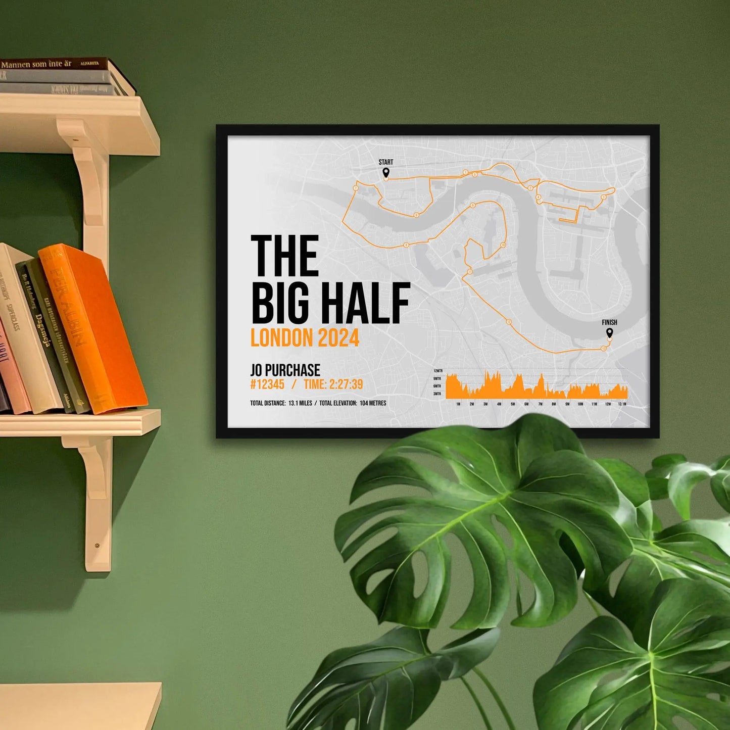 Framed art print on a green wall beside shelves.