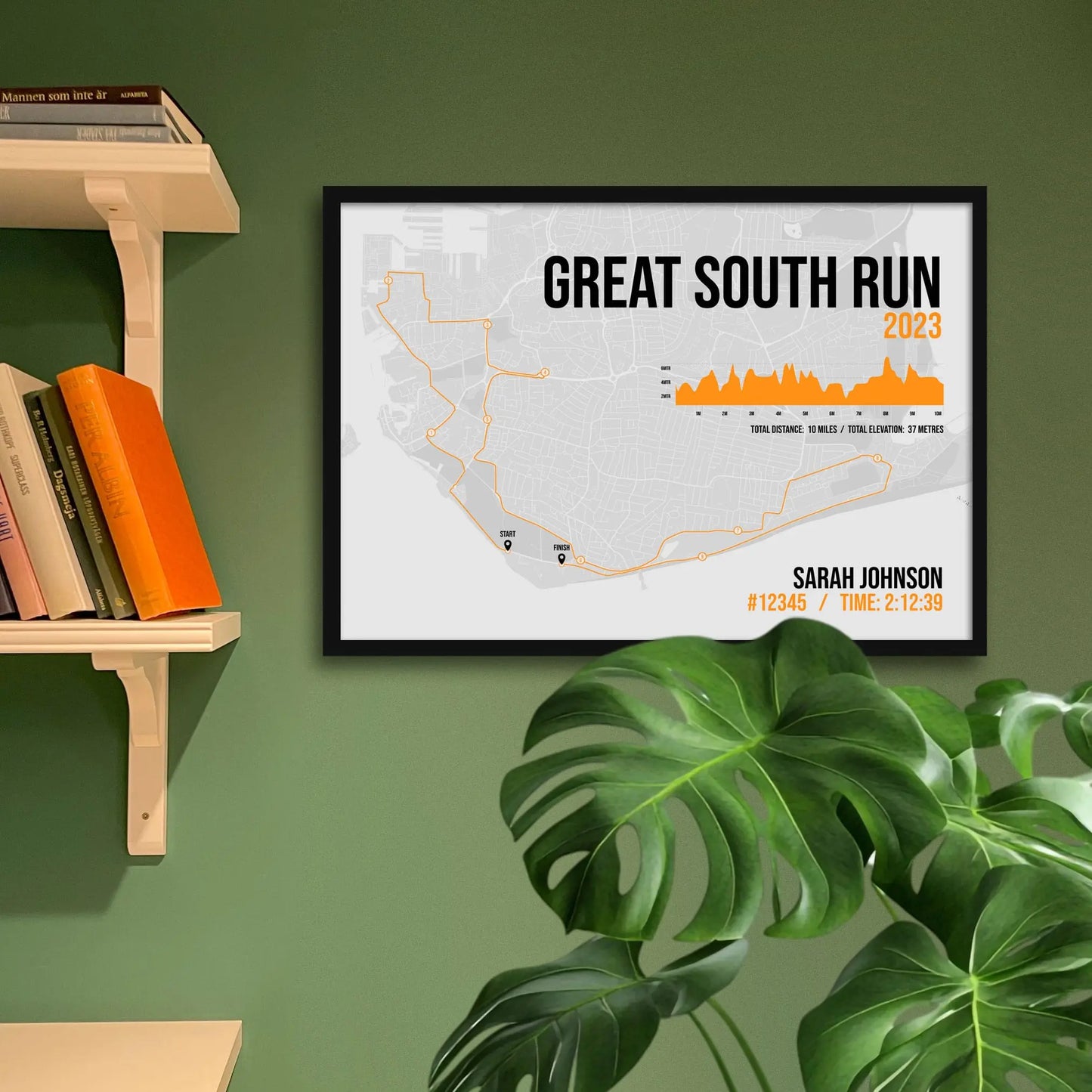 Framed art print on a green wall beside shelves.