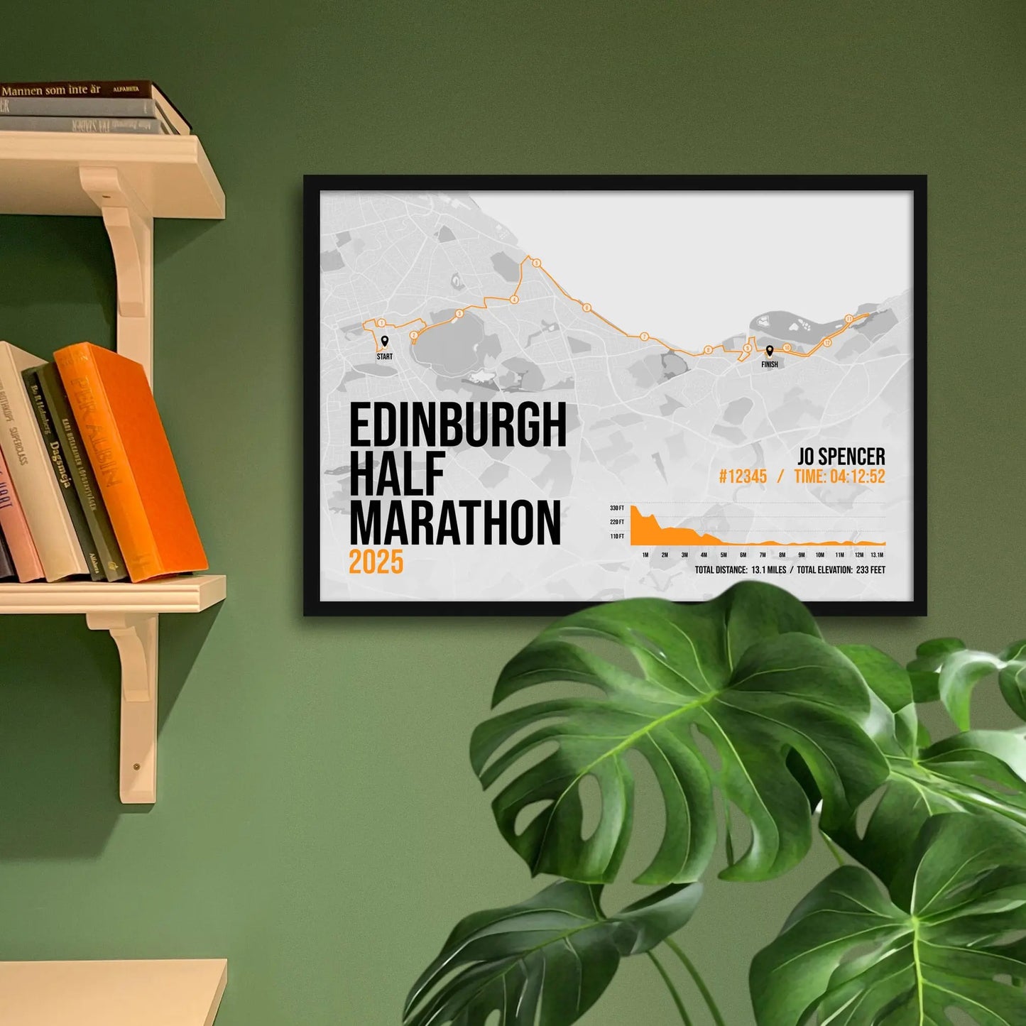 Framed art print on a green wall beside shelves.