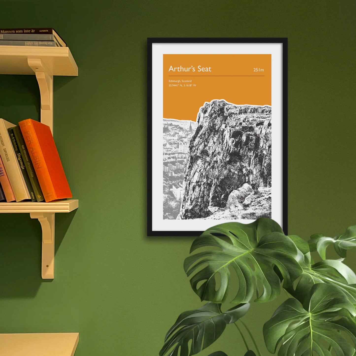 Framed art print on a green wall beside shelves.