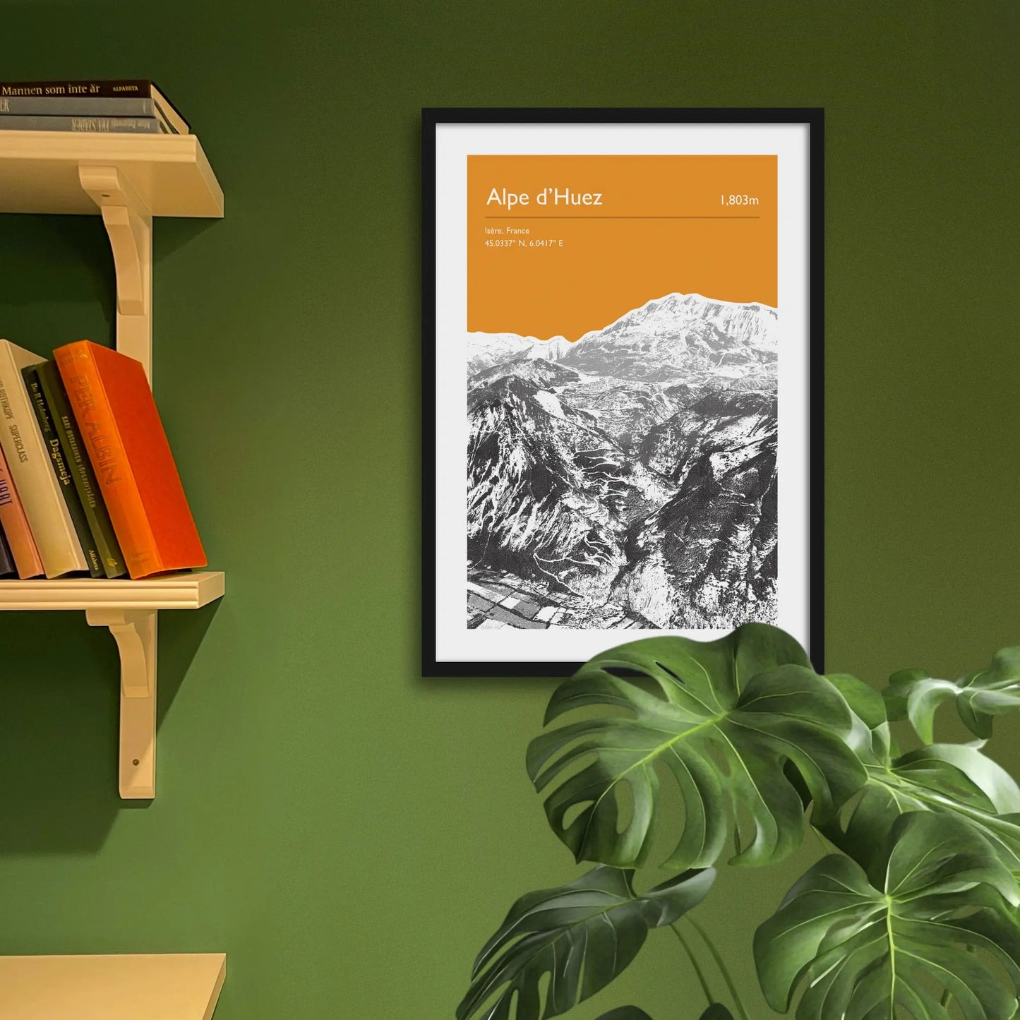 Framed art print on a green wall beside shelves.