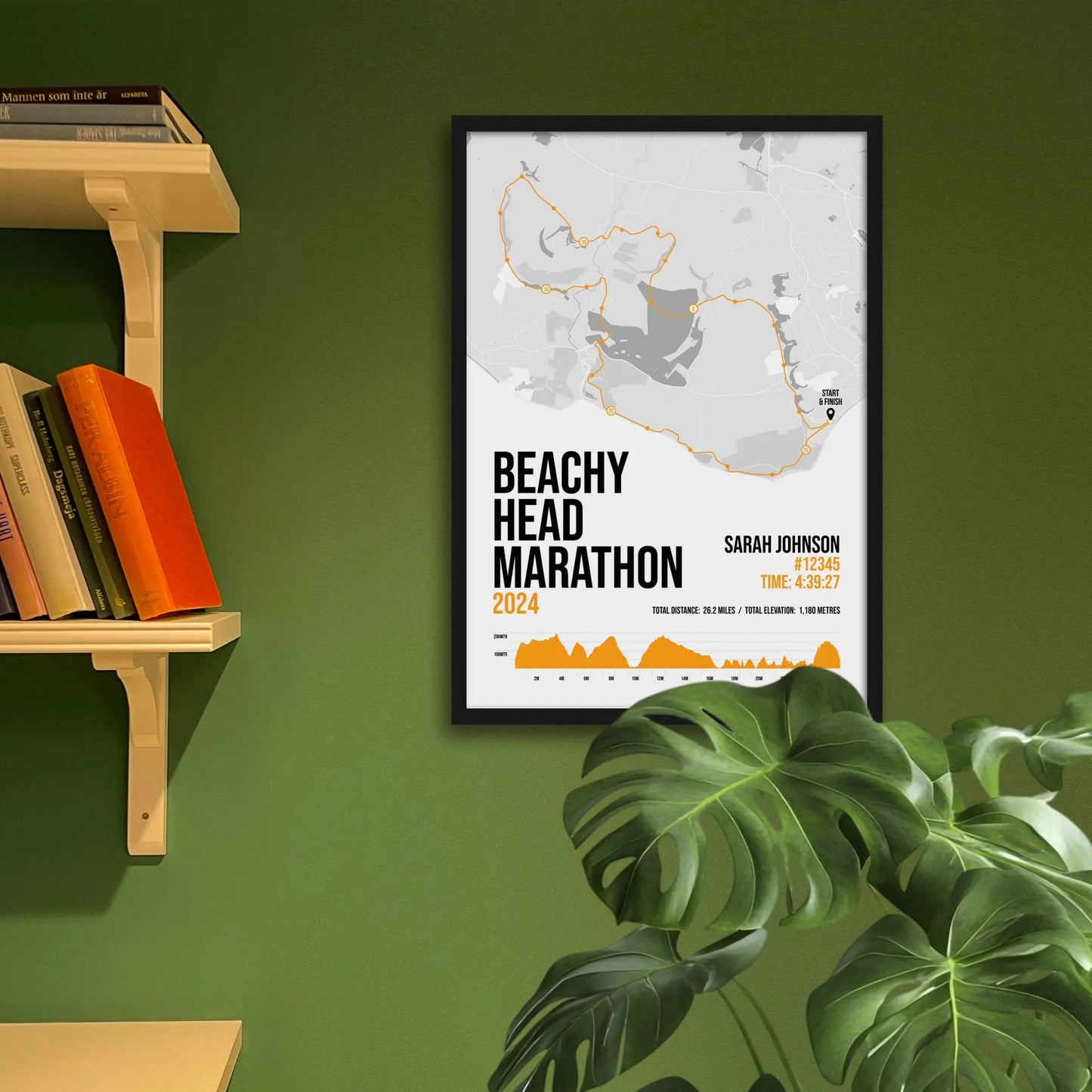 Framed art print on a green wall beside shelves.