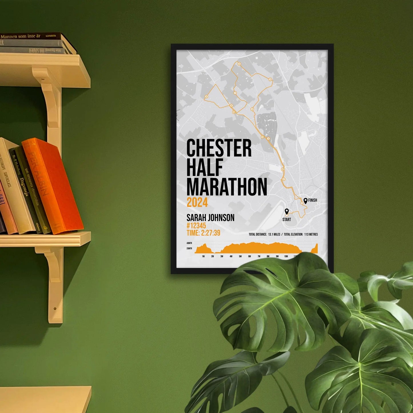 Framed art print on a green wall beside shelves.