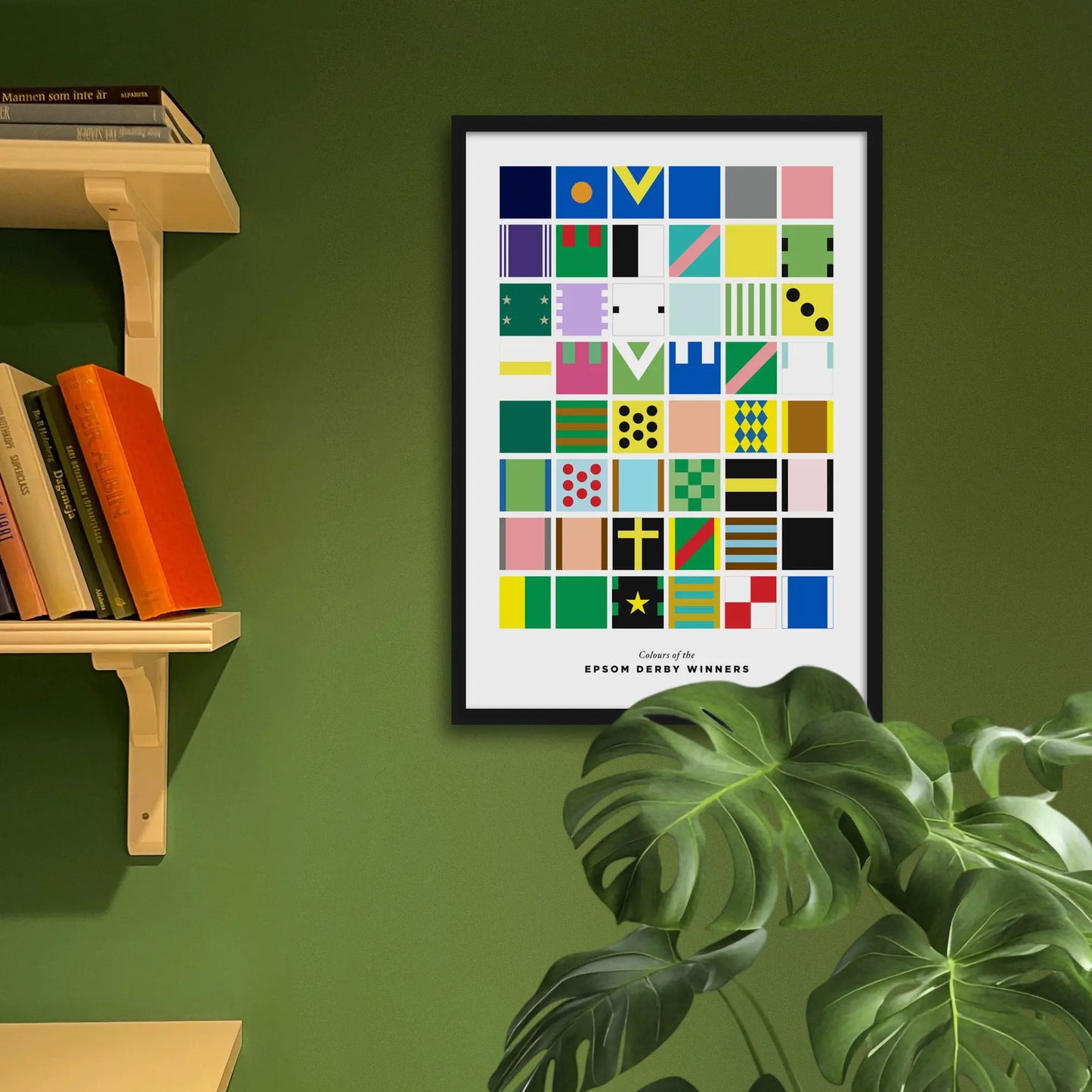 Framed art print on a green wall beside shelves.