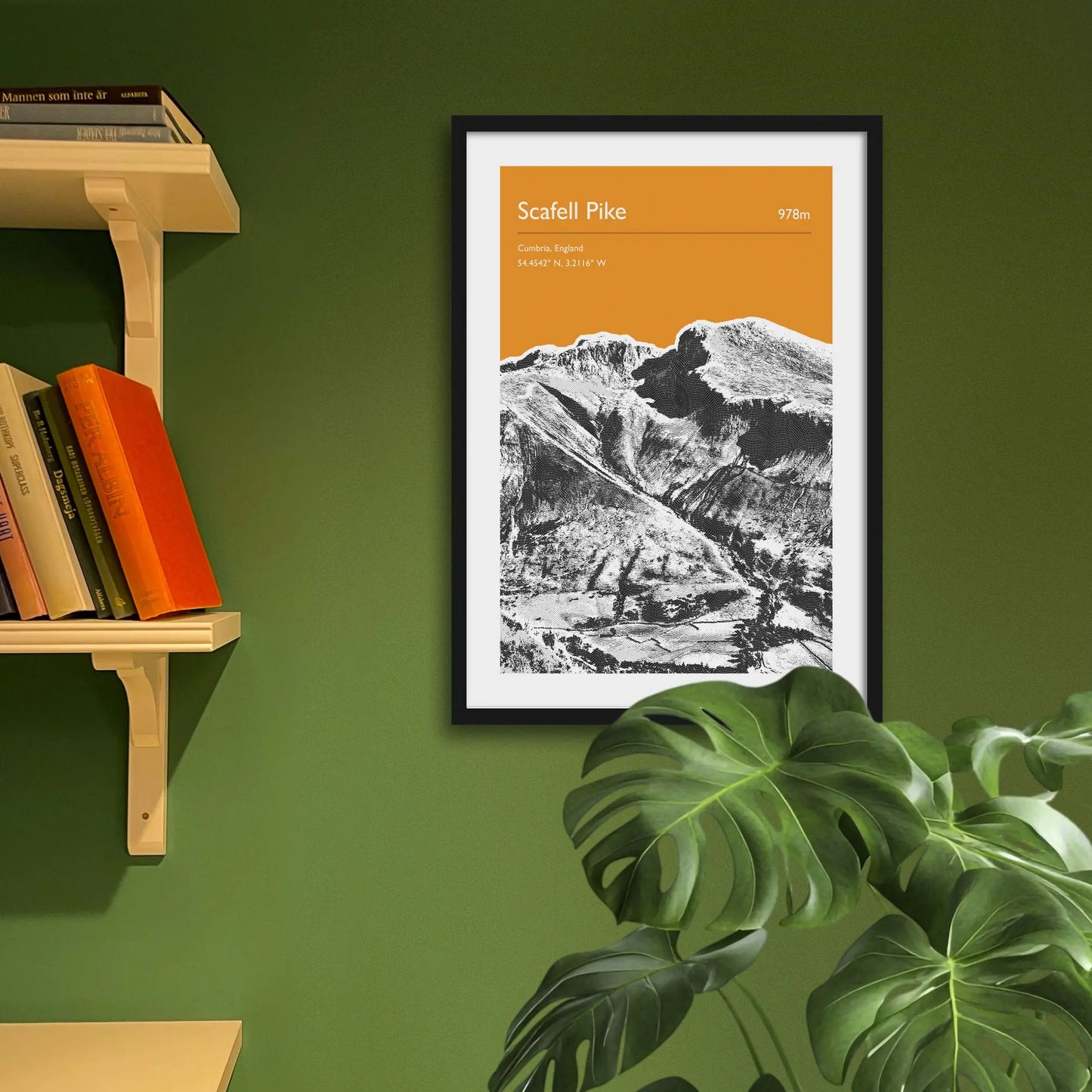 Framed art print on a green wall beside shelves.