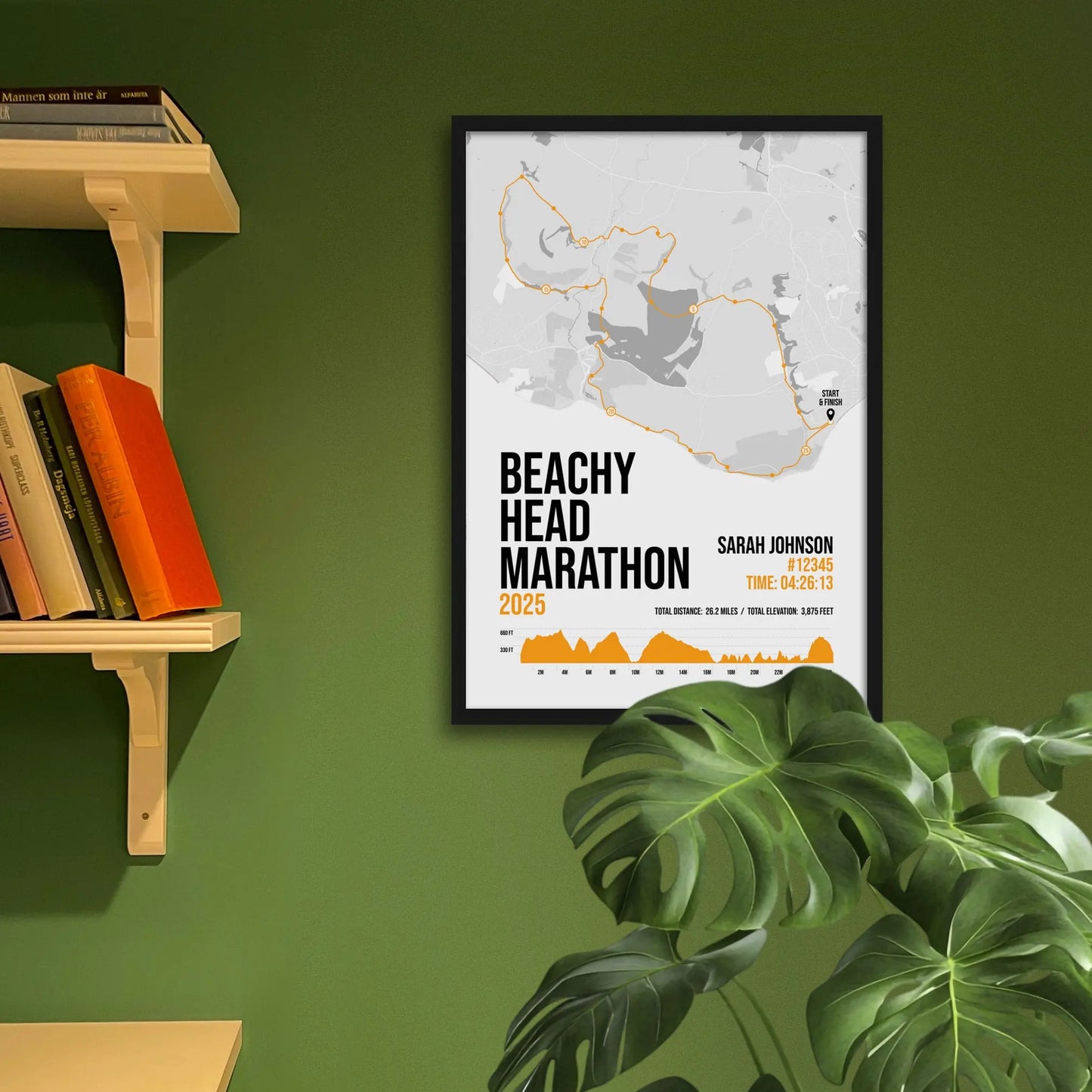 Framed art print on a green wall beside shelves.