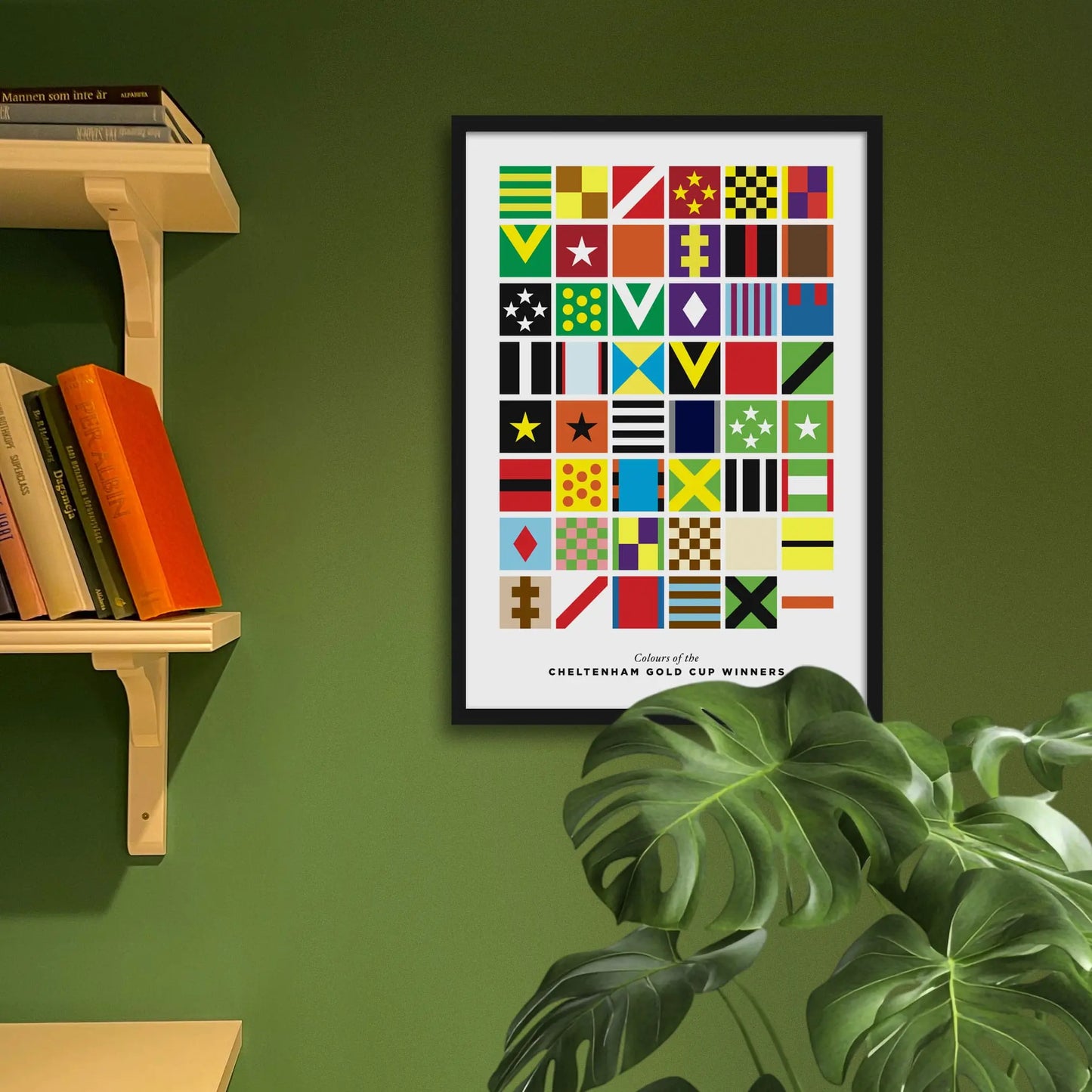 Framed print on green wall beside shelving