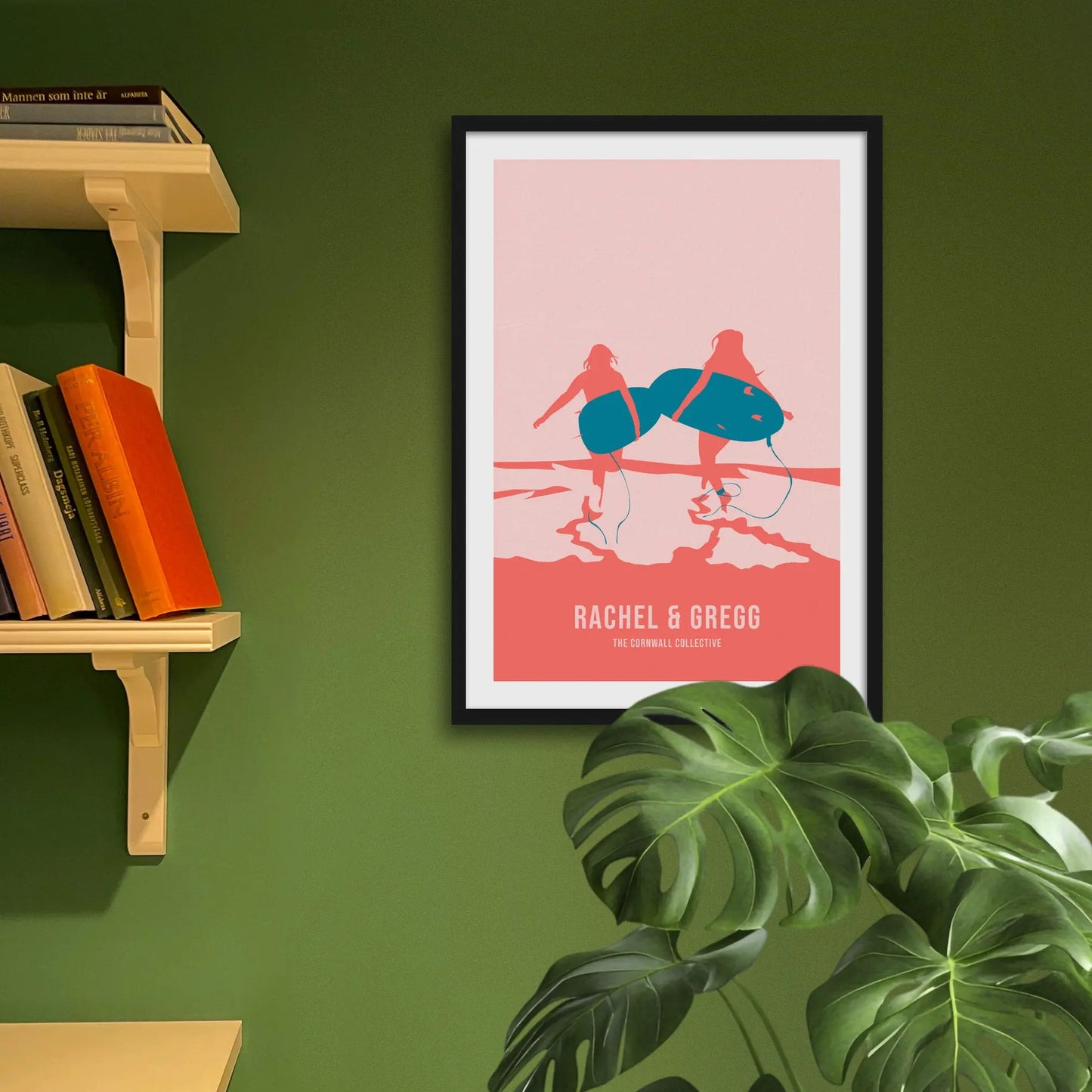 Framed art print on a green wall beside shelves.
