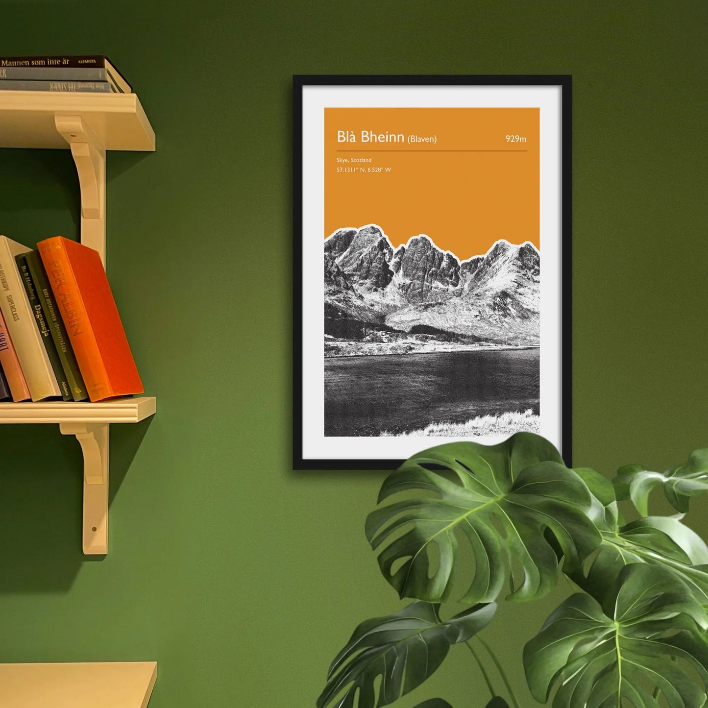 Framed art print on a green wall beside shelves.