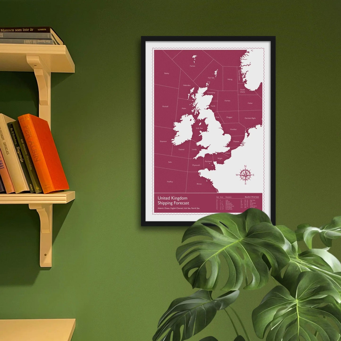 Framed art print on a green wall beside shelves.