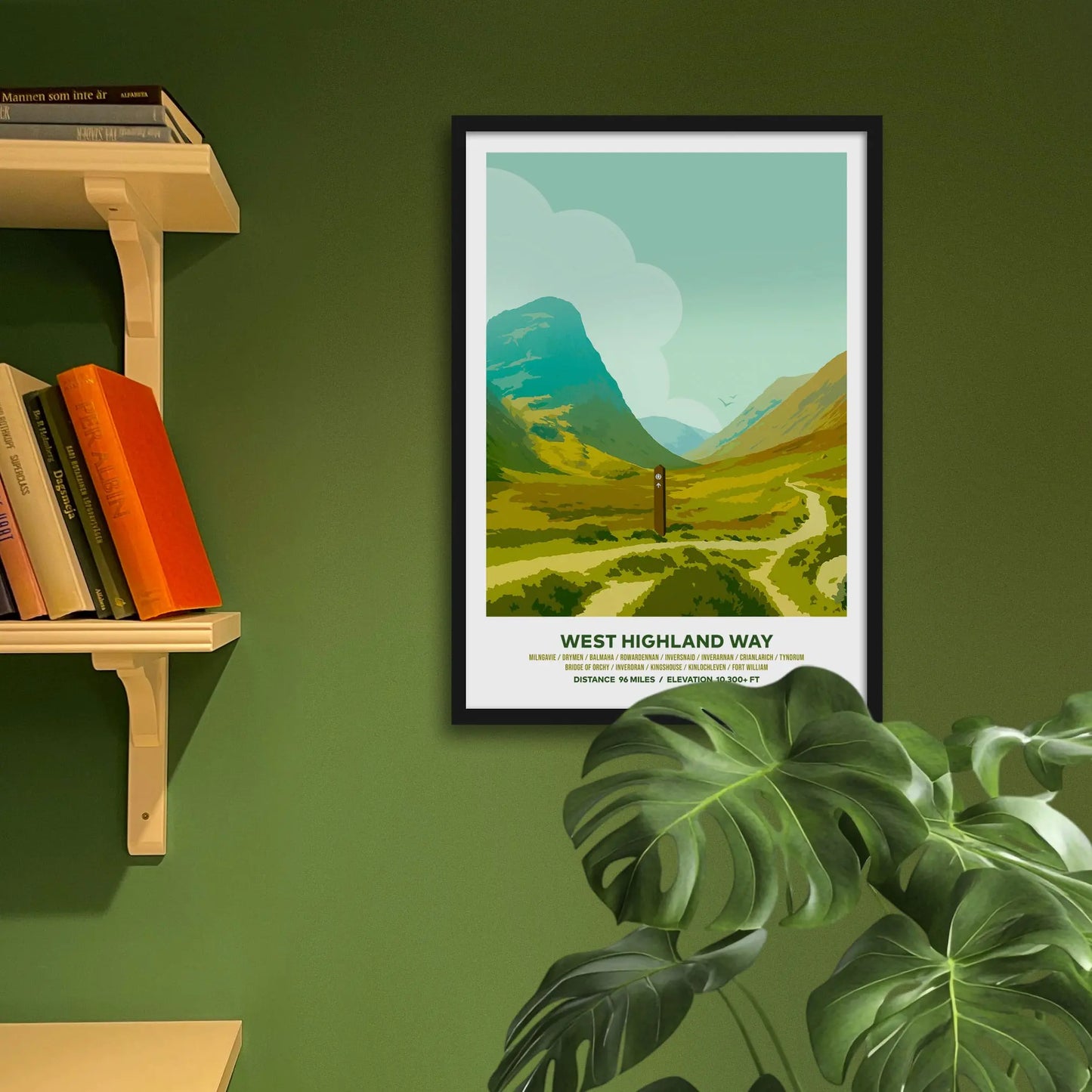 Framed art print on a green wall beside shelves.