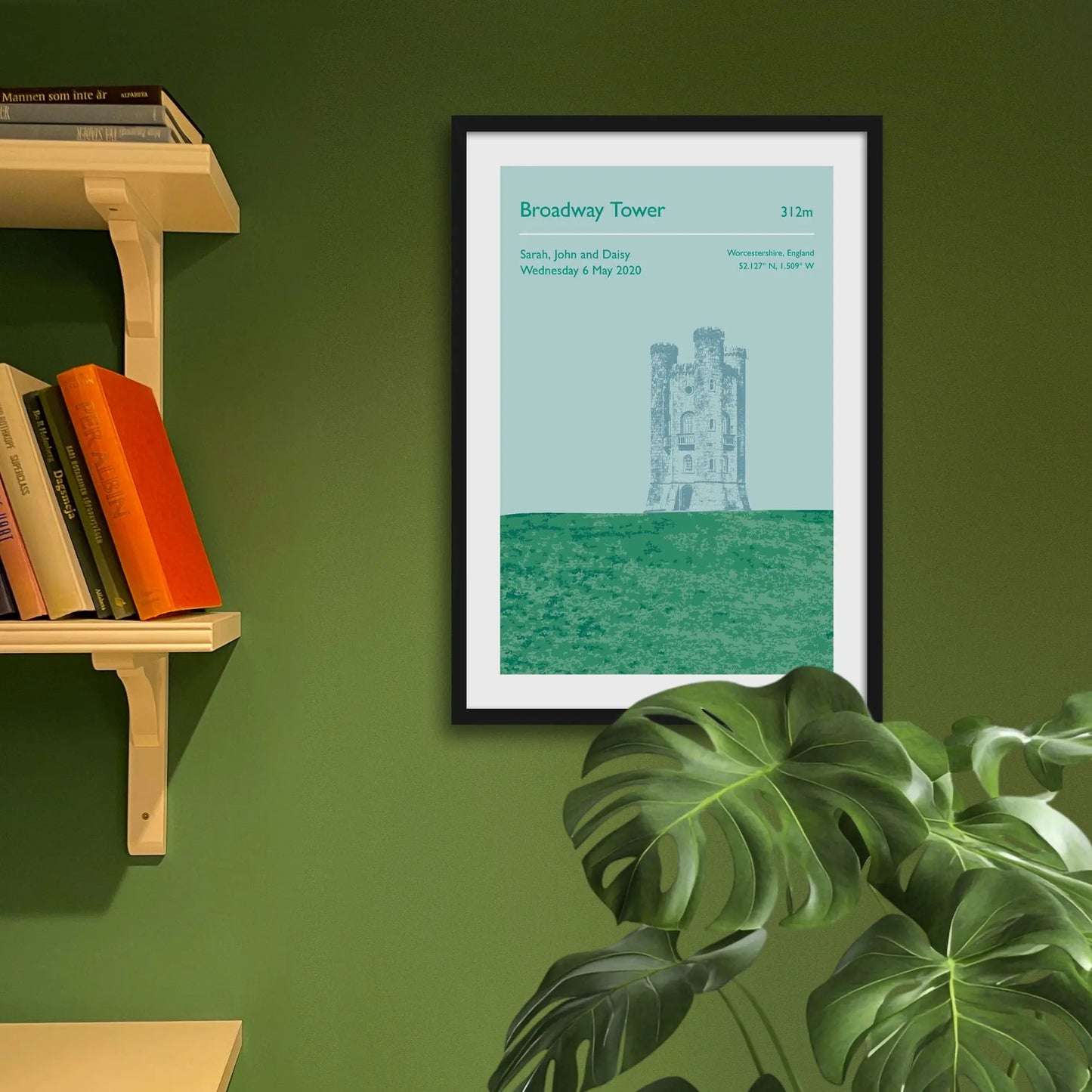 Framed art print on a green wall beside shelves.