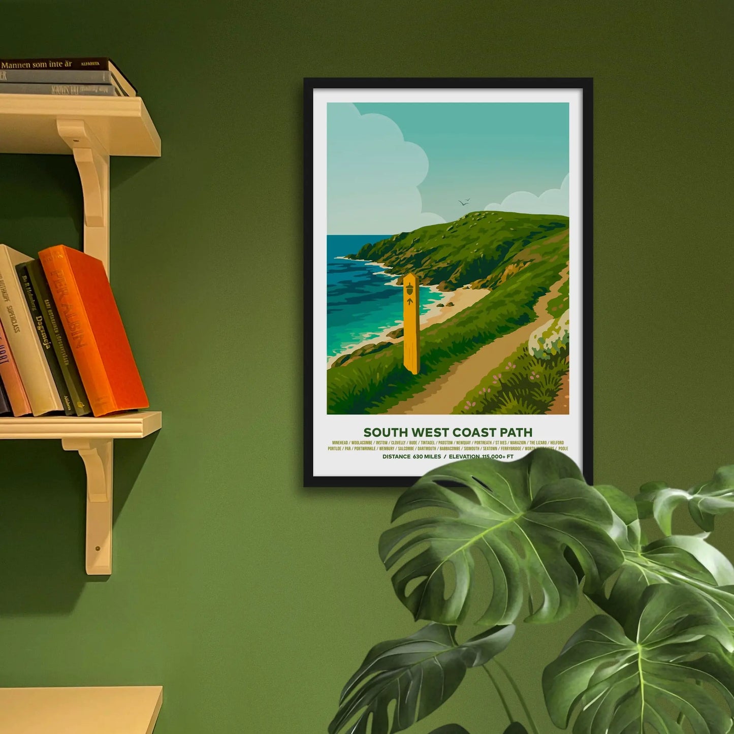 Framed art print on a green wall beside shelves.