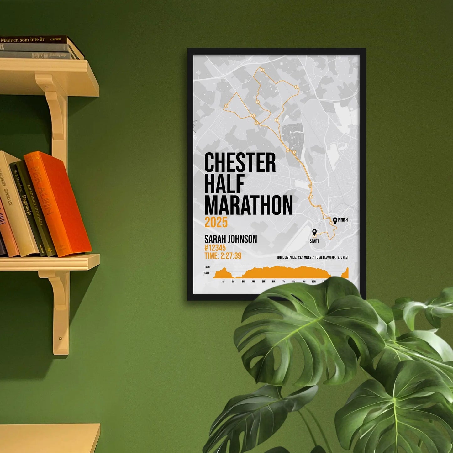 Framed art print on a green wall beside shelves.