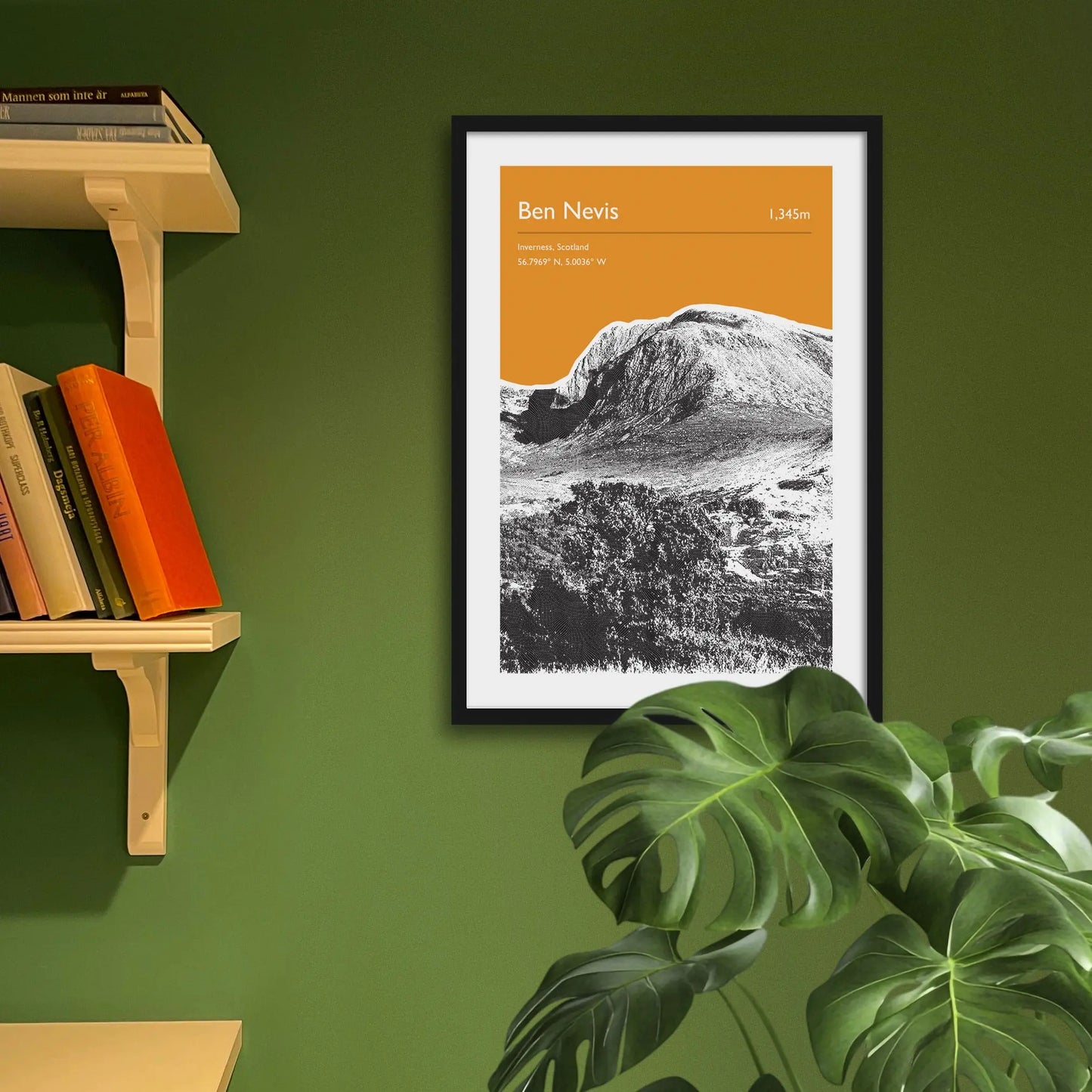 Framed art print on a green wall beside shelves.