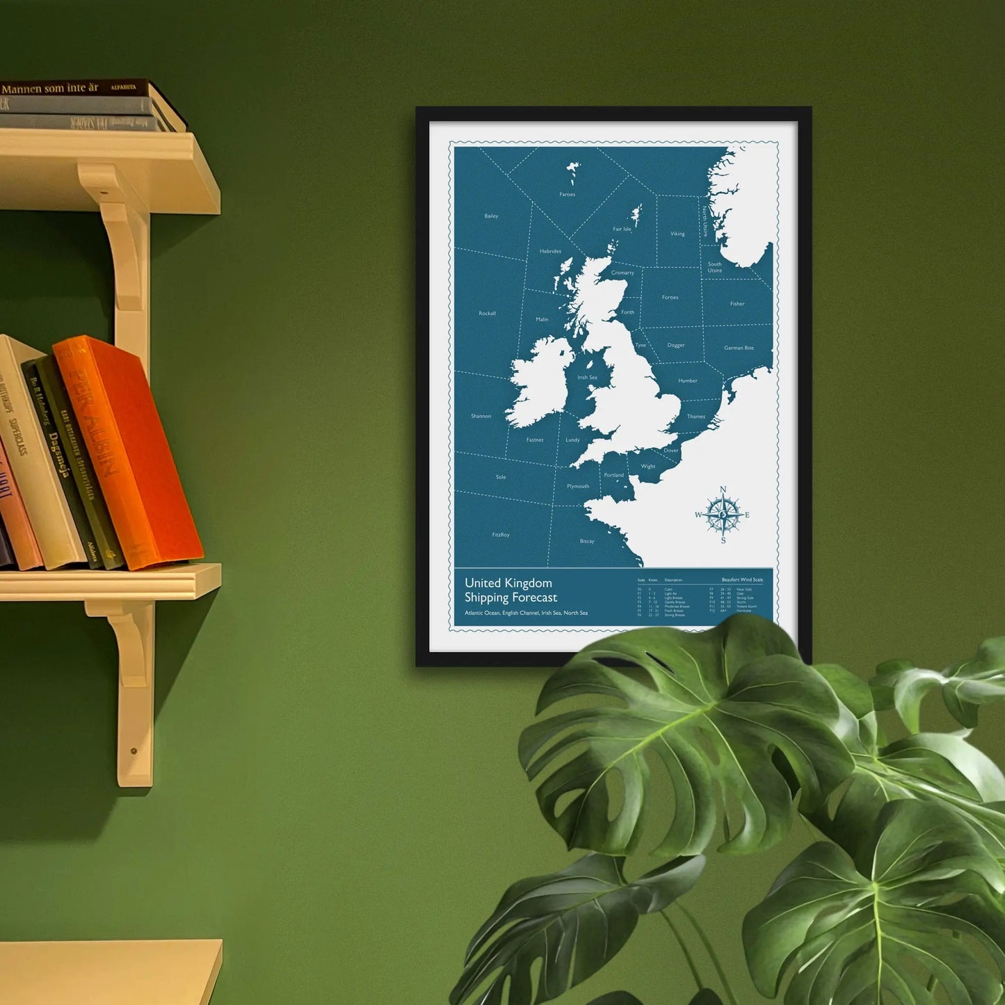 Framed art print on a green wall beside shelves.