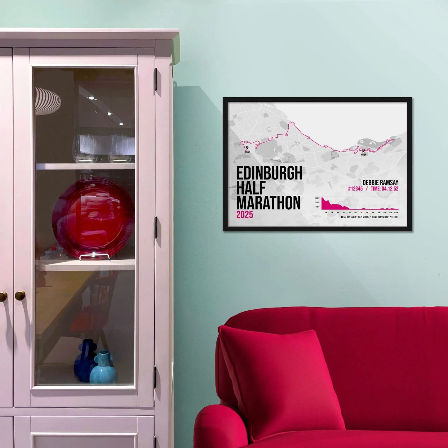 Framed picture on a baby blue wall beside pink shelving