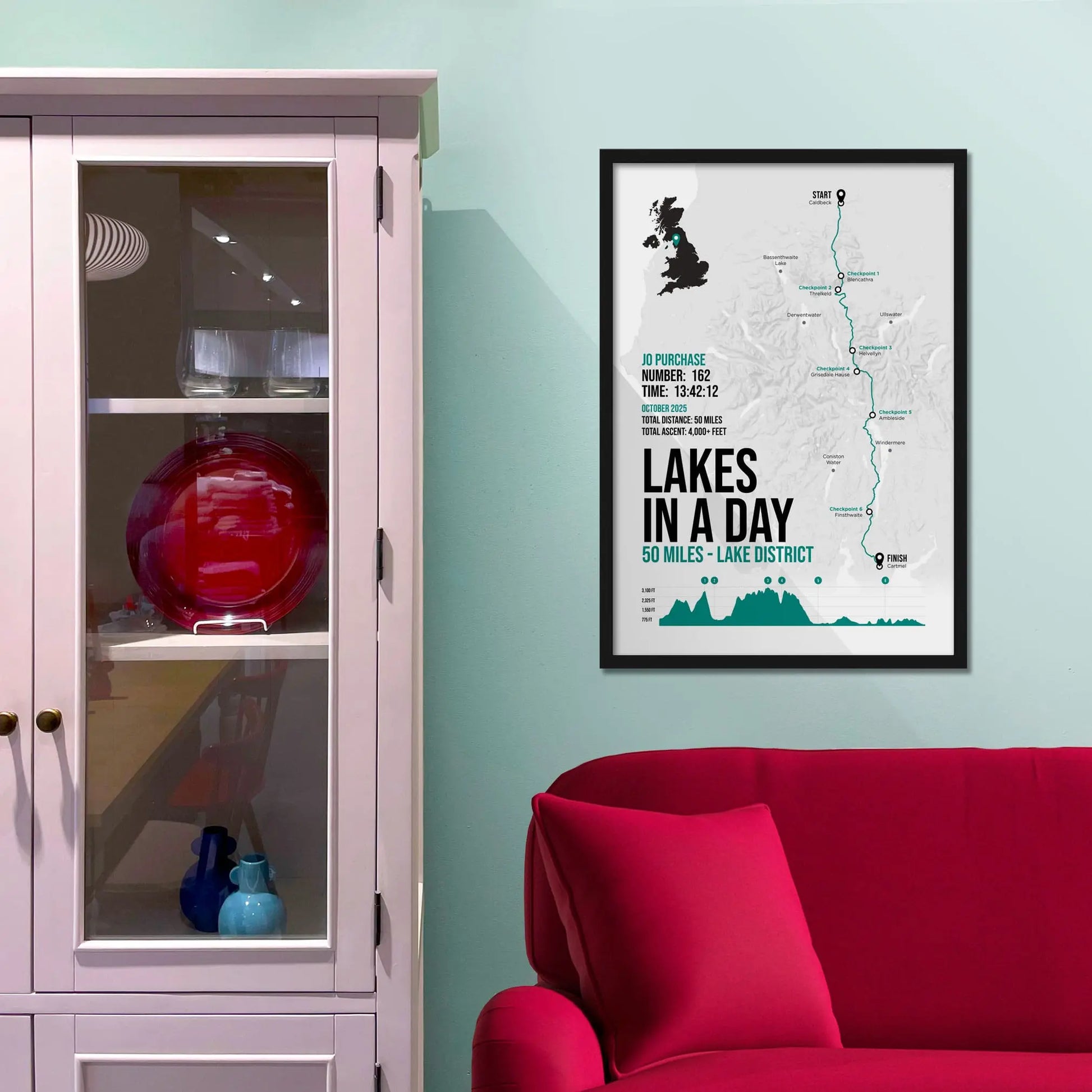 Framed picture on a baby blue wall beside pink shelving