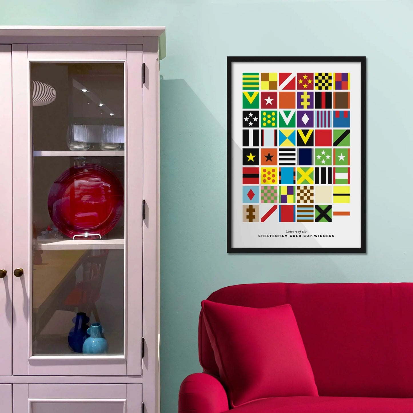 Framed picture on a baby blue wall beside pink shelving