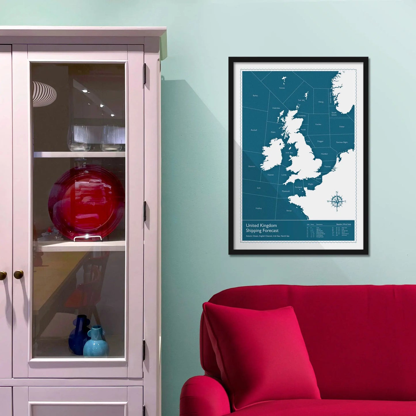 Framed picture on a baby blue wall beside pink shelving