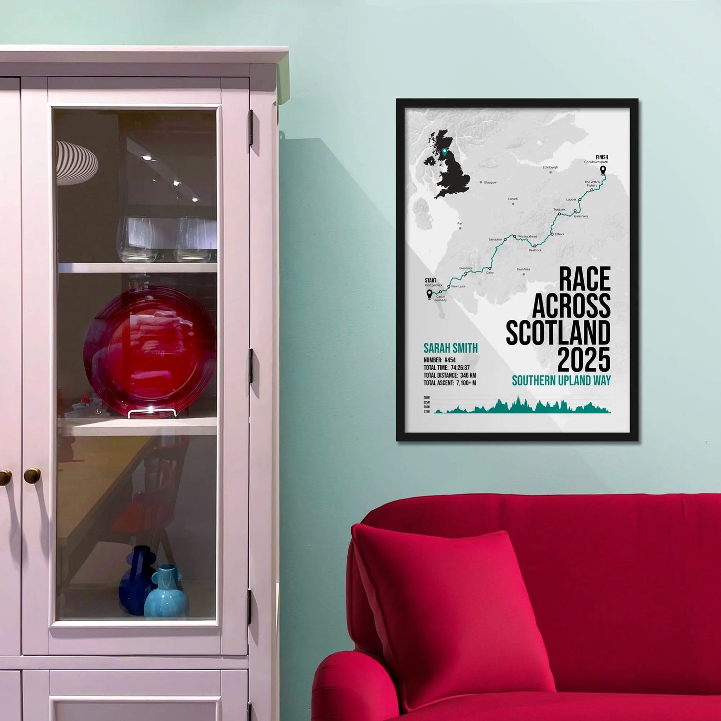Framed print on light blue wall beside pink shelving unit.