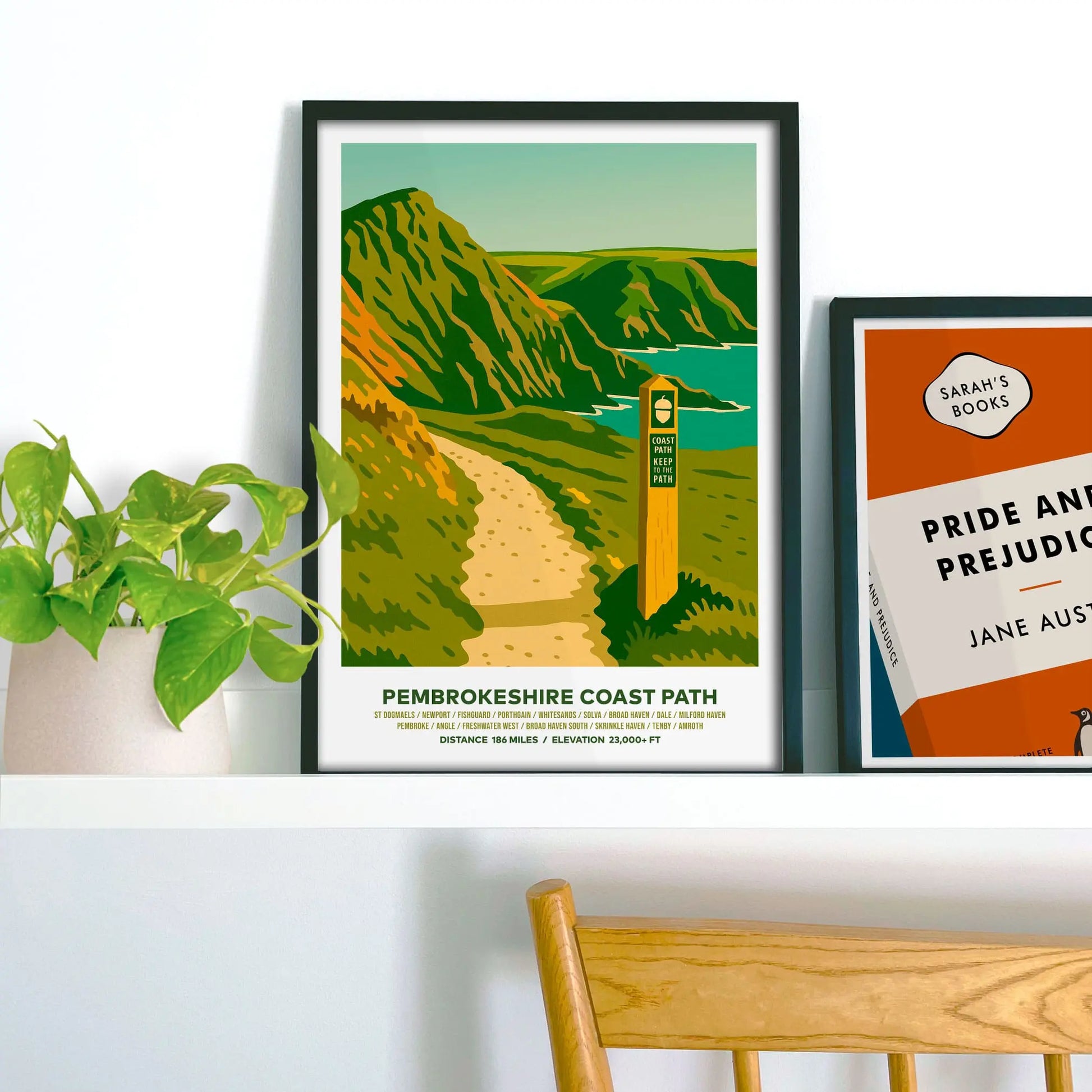 Framed print on shelf beside houseplant