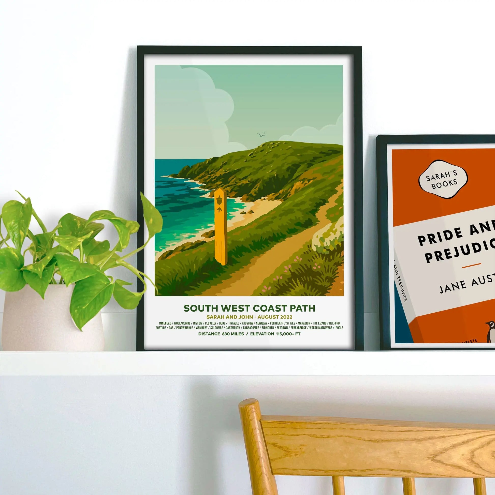 Framed print on shelf beside houseplant