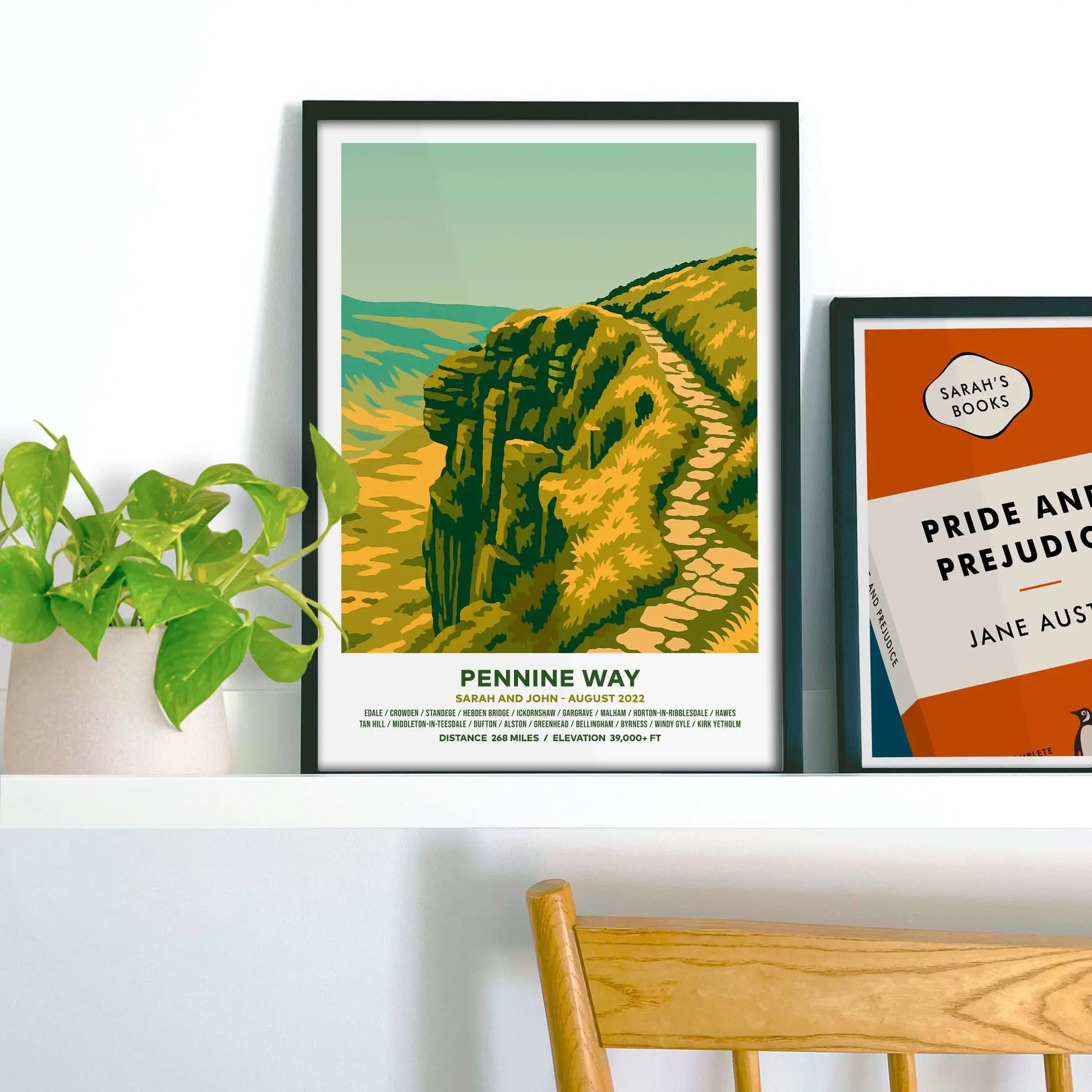 Framed print on shelf beside houseplant