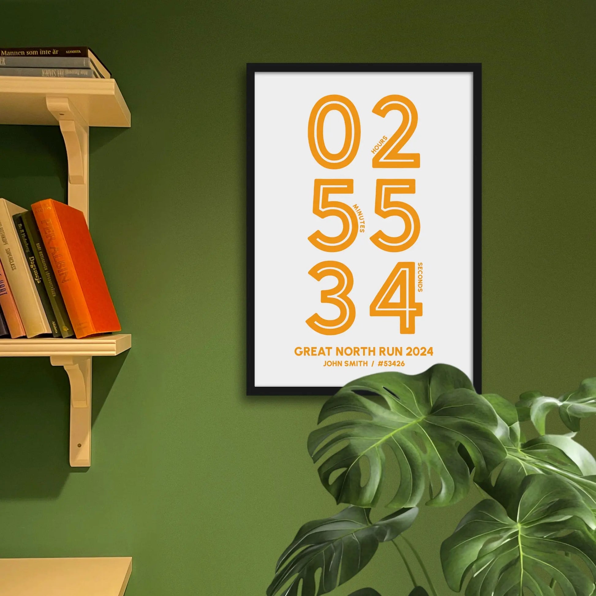 Framed art print on a green wall beside shelves.