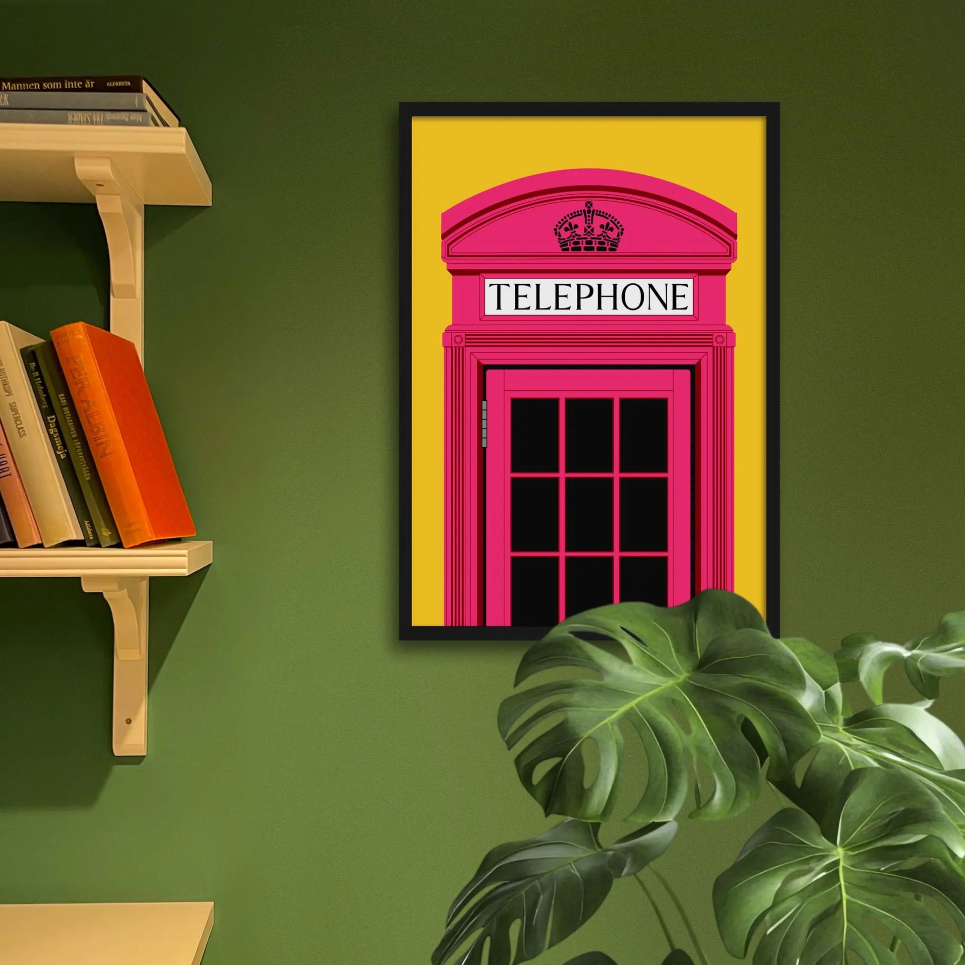 Framed art print on a green wall beside shelves.