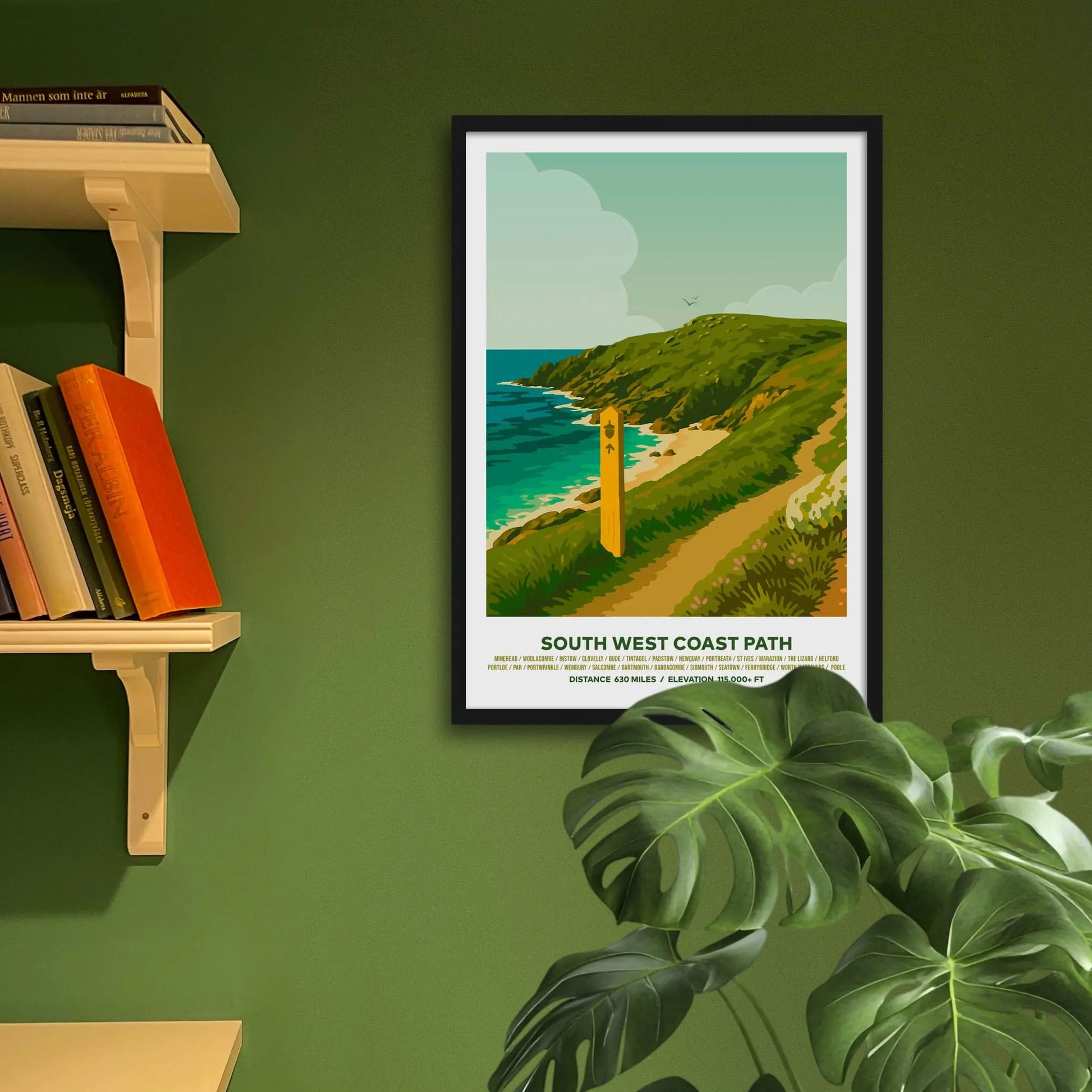 Framed art print on a green wall beside shelves.
