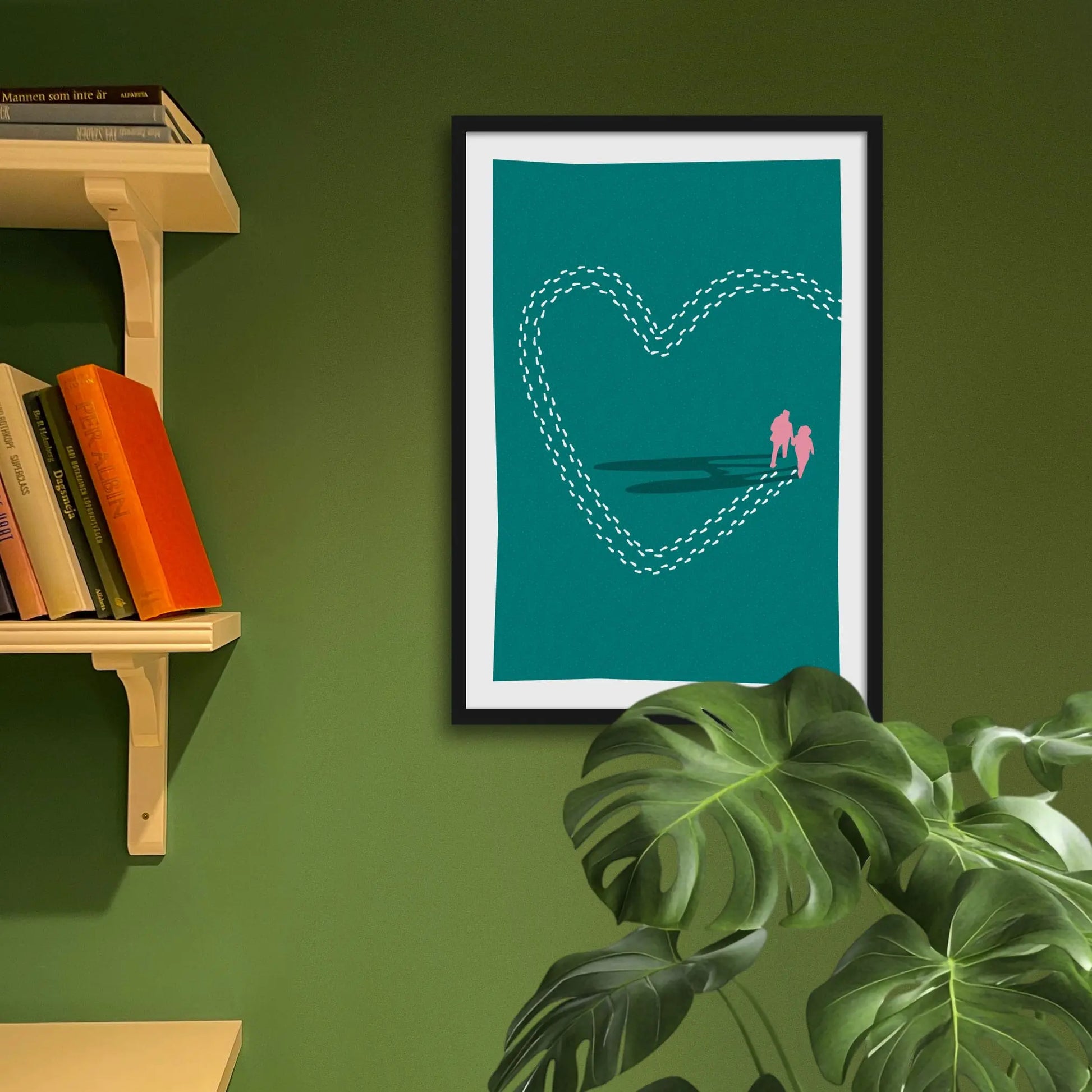 Framed art print on a green wall beside shelves.