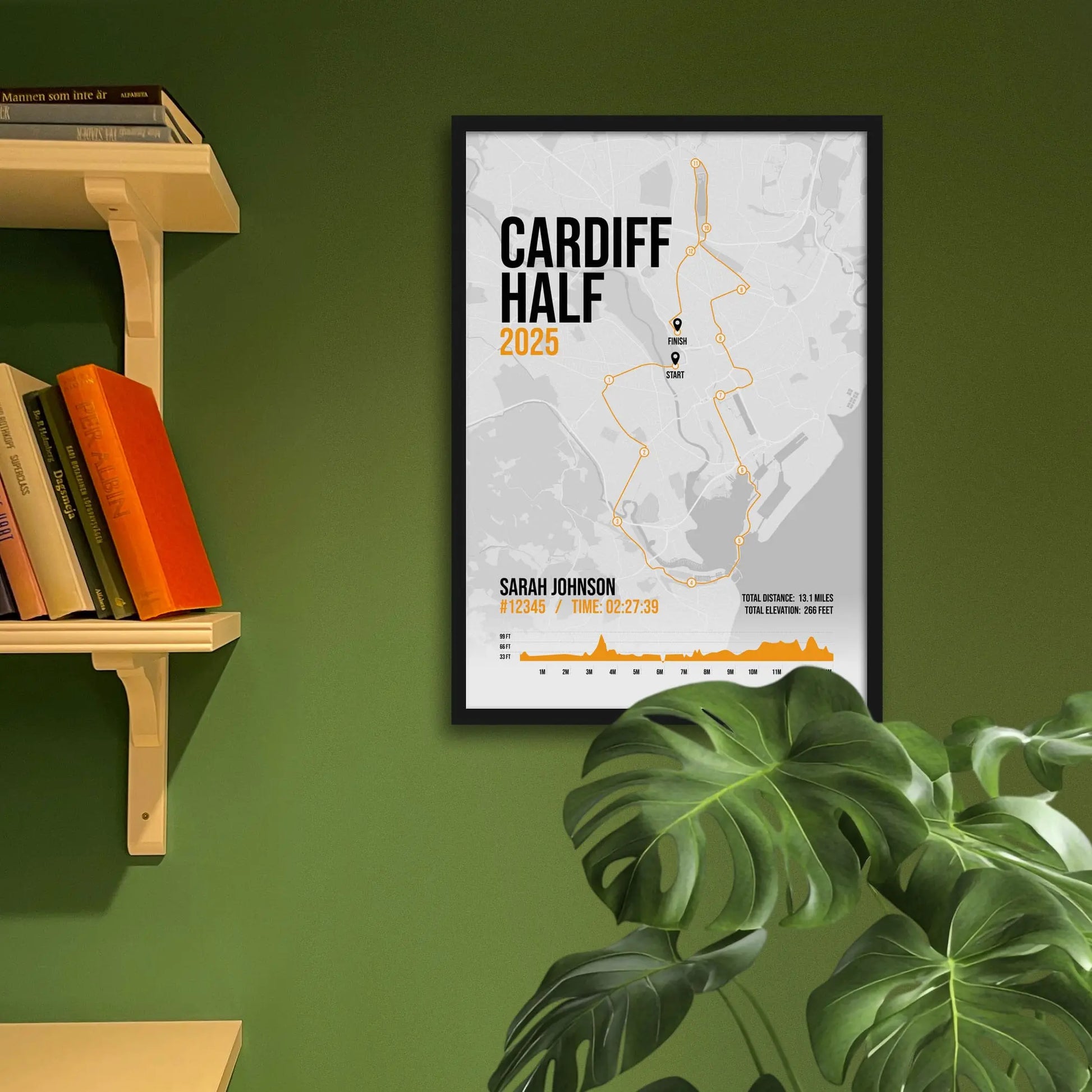 Framed art print on a green wall beside shelves.