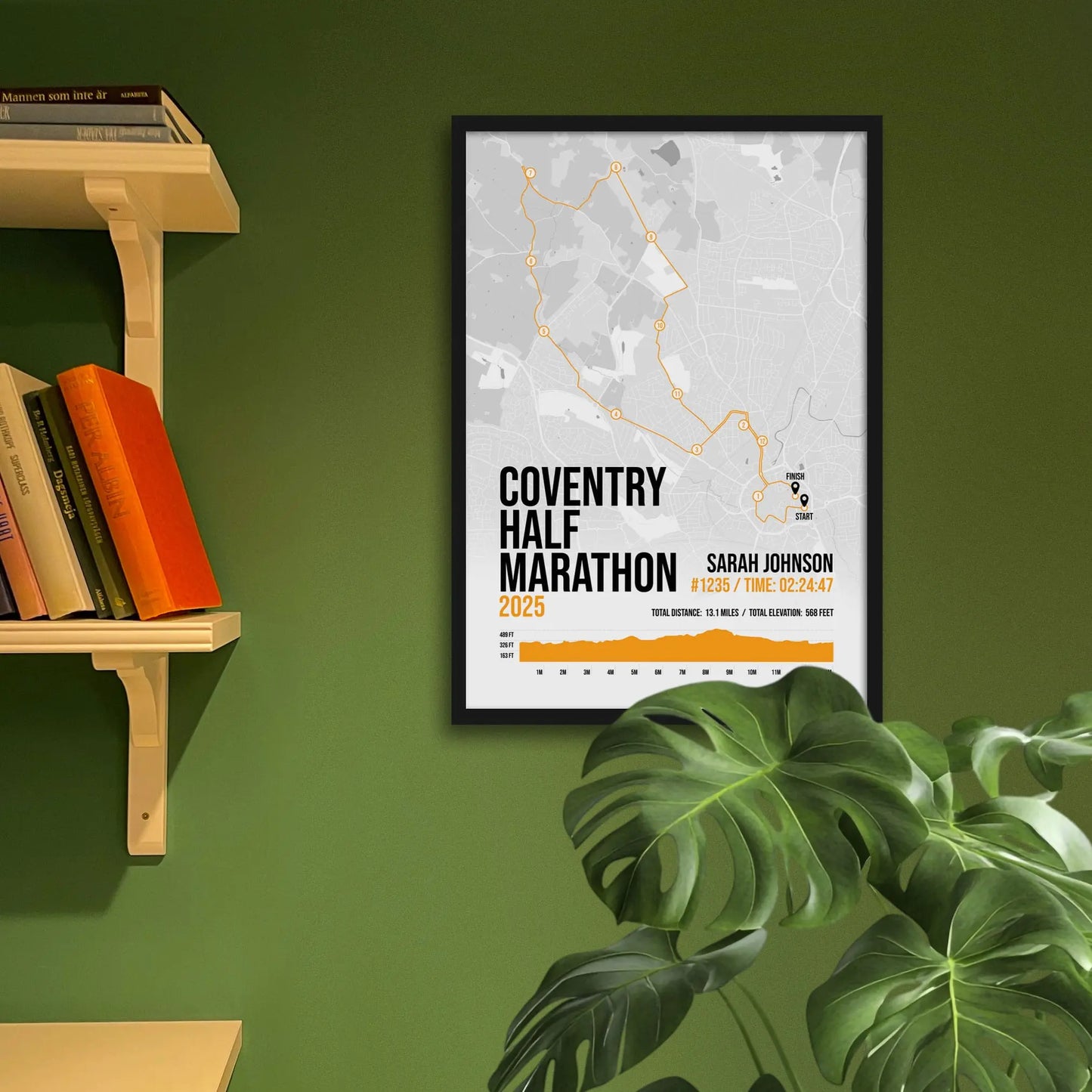 Framed art print on a green wall beside shelves.