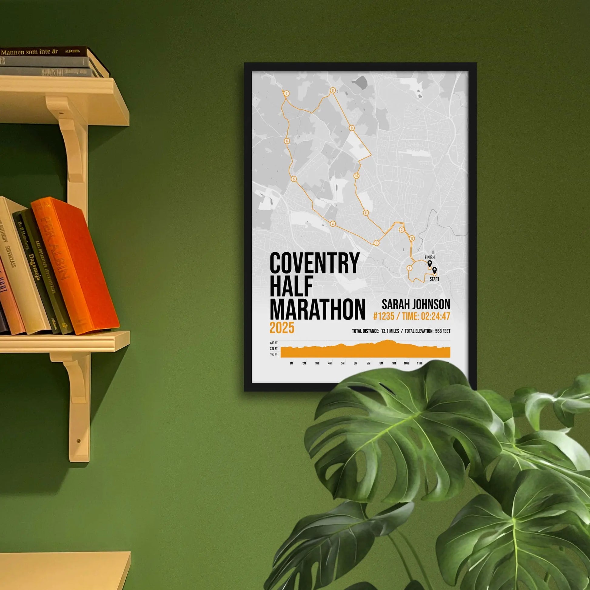 Framed art print on a green wall beside shelves.