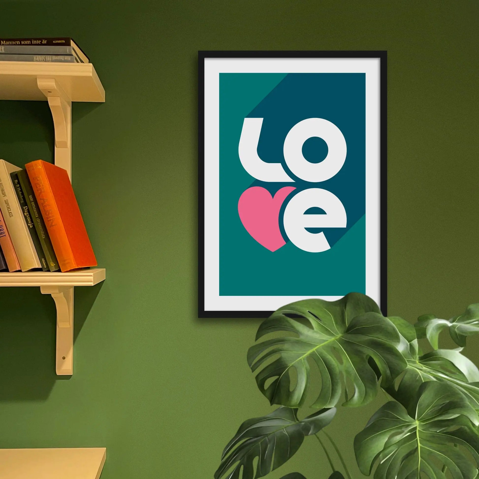 Framed art print on a green wall beside shelves.