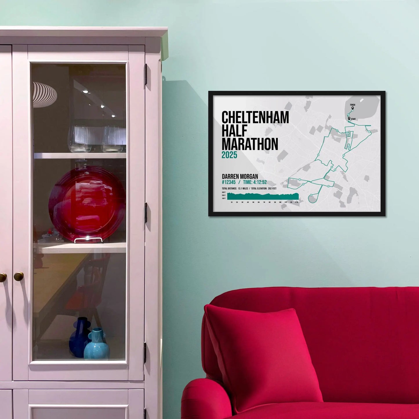 Framed picture on a baby blue wall beside pink shelving