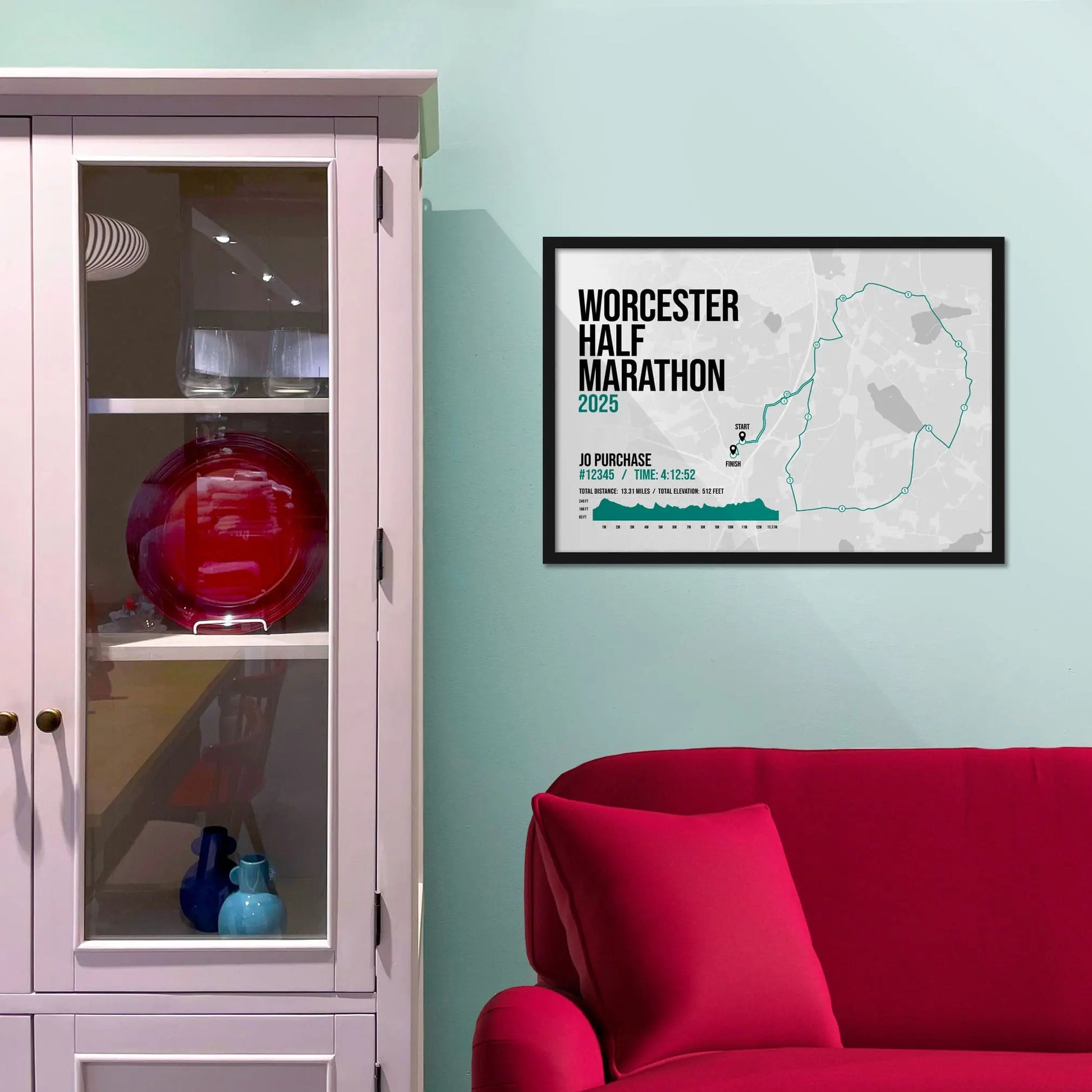 Framed picture on a baby blue wall beside pink shelving