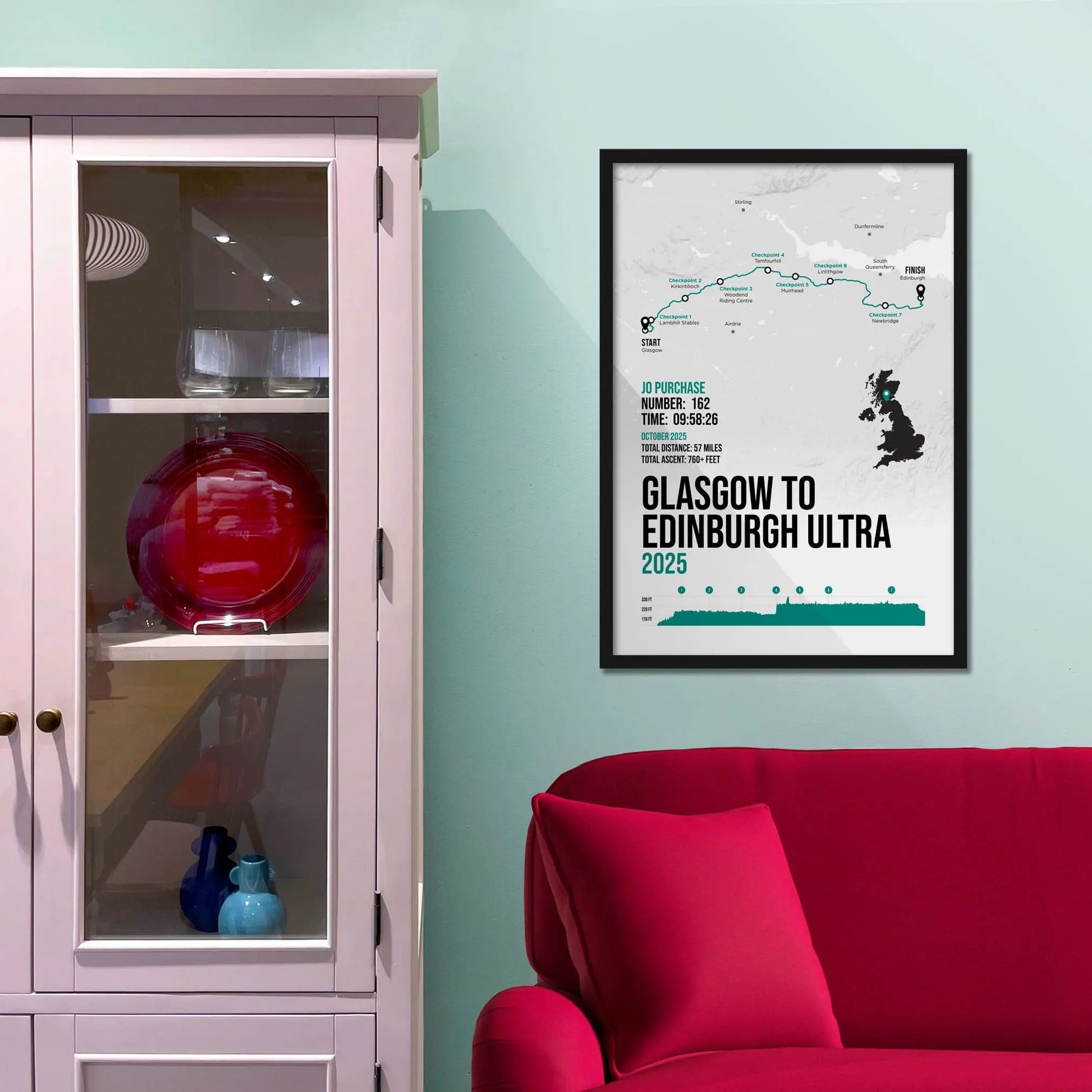 Framed print on light blue wall beside pink shelving unit.