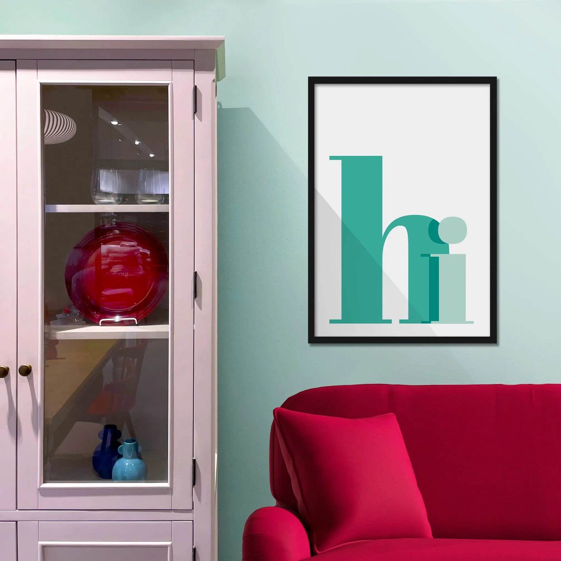 Framed picture on a baby blue wall beside pink shelving