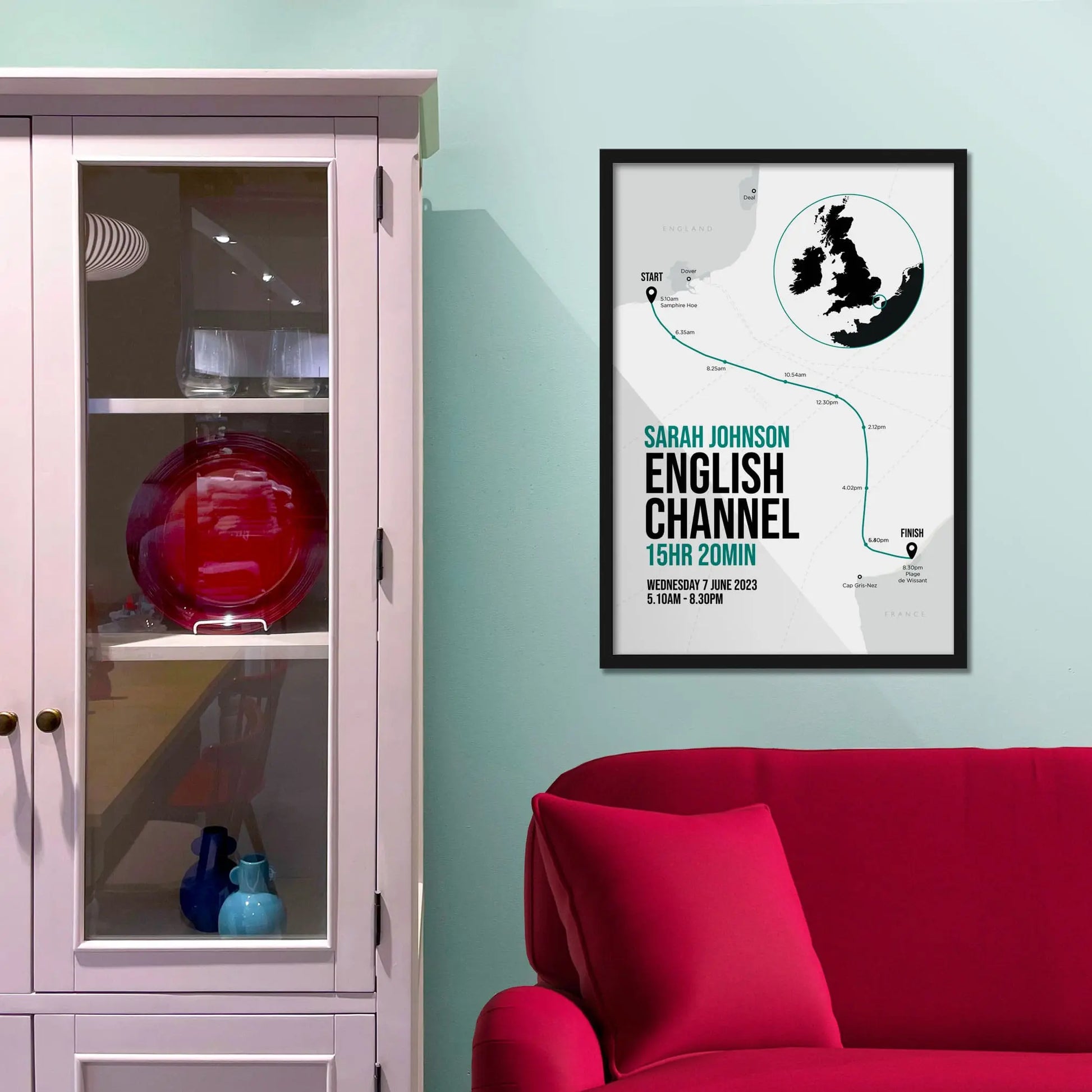 Framed picture on a baby blue wall beside pink shelving