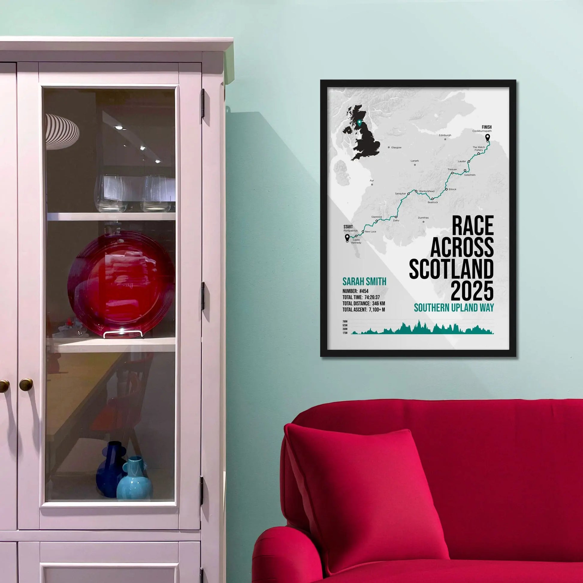 Framed print on light blue wall beside pink shelving unit.