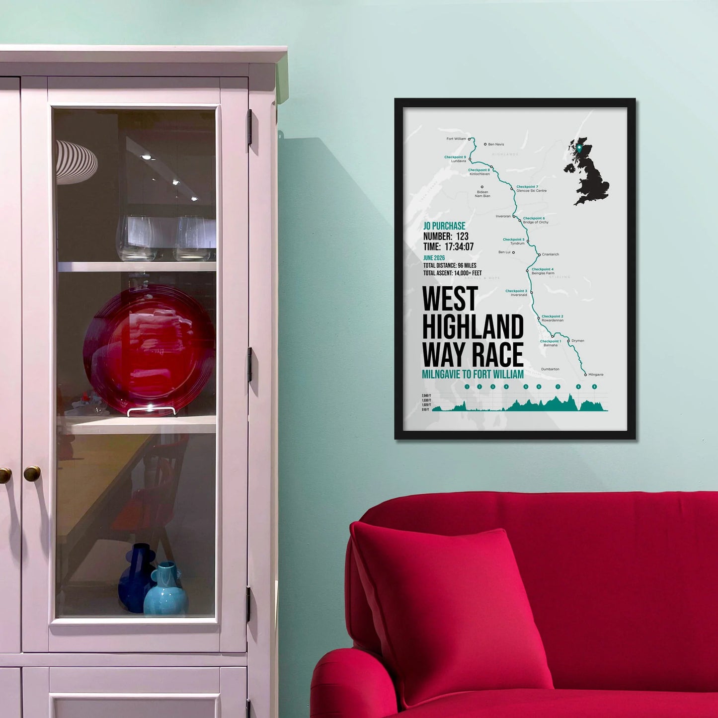 Framed picture on a baby blue wall beside pink shelving