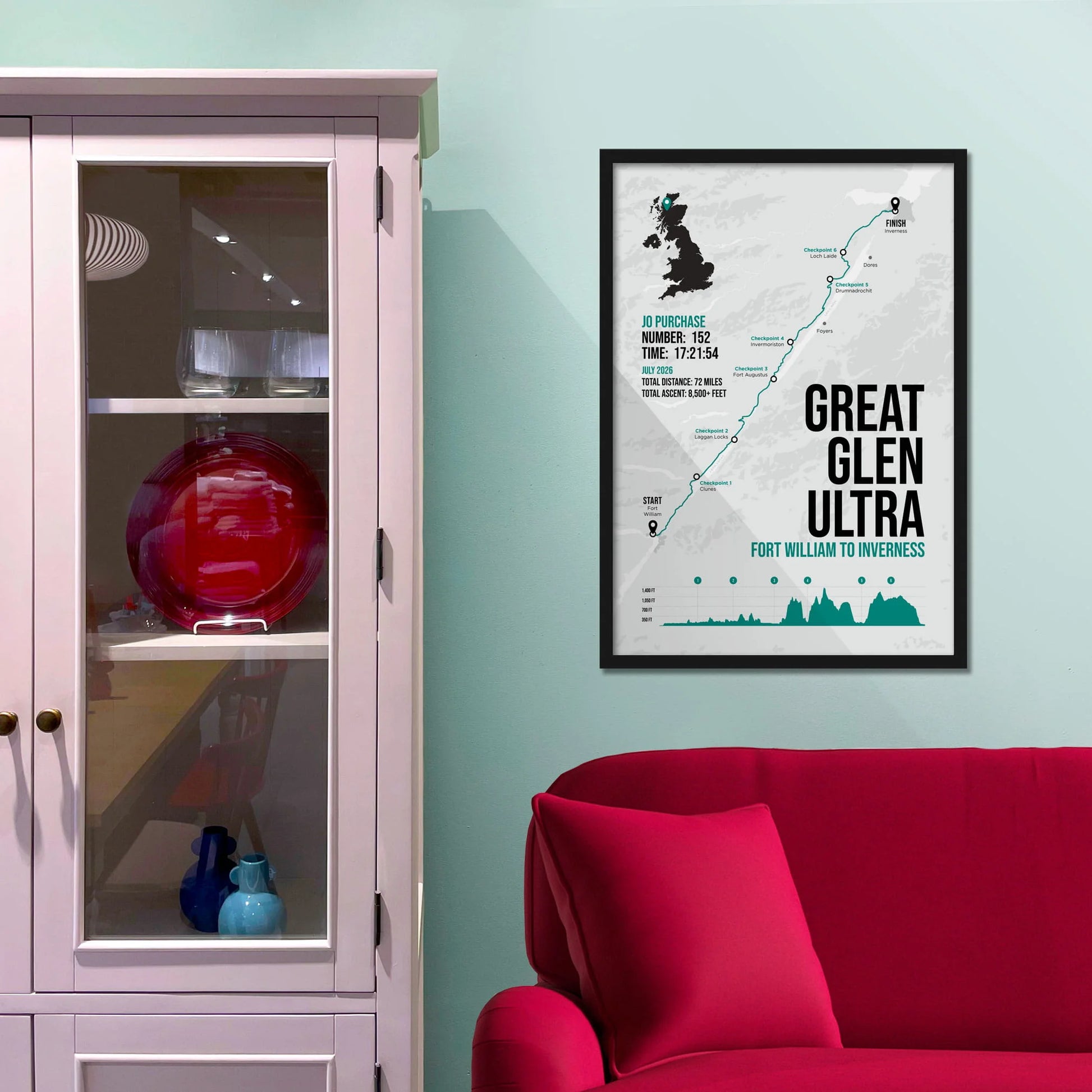 Framed picture on a baby blue wall beside pink shelving