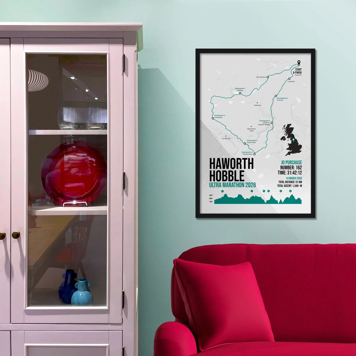 Framed picture on a baby blue wall beside pink shelving