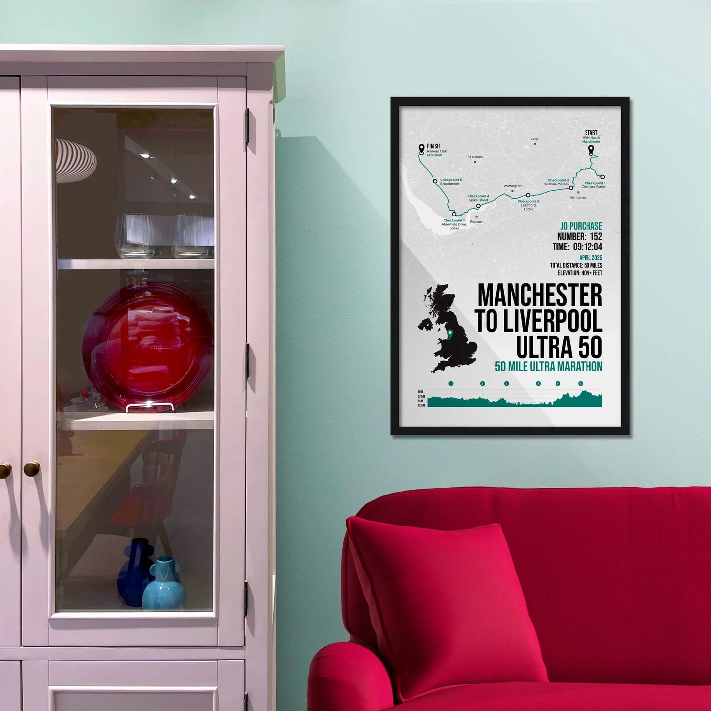 Framed picture on a baby blue wall beside pink shelving