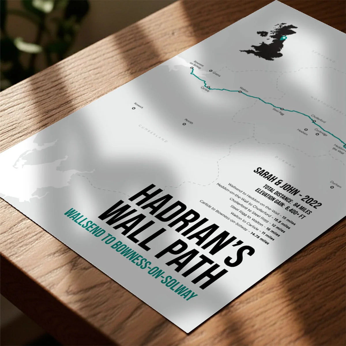 Print laying on table with speckled shade cast across the surface