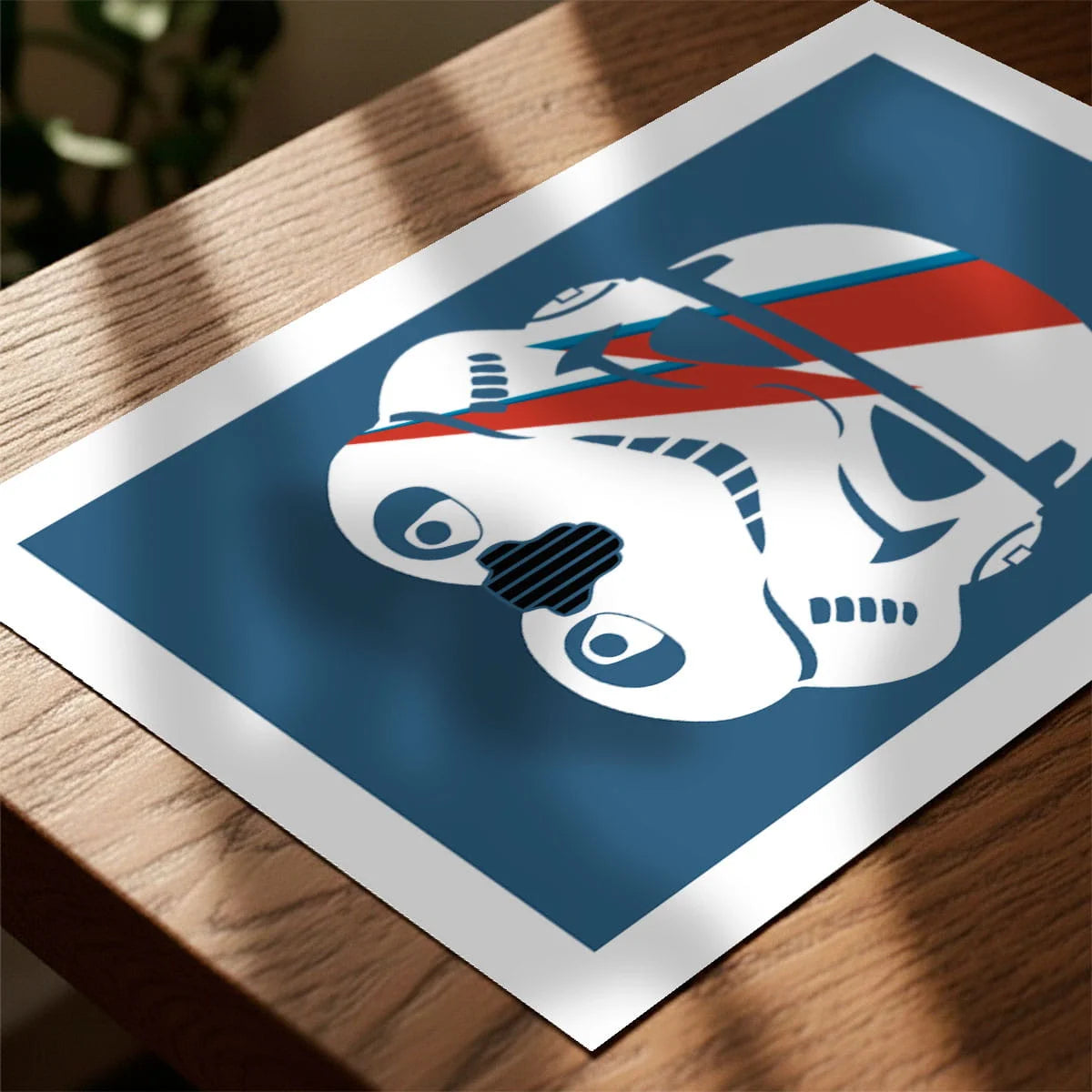 Framed print on sideboard beside a plant