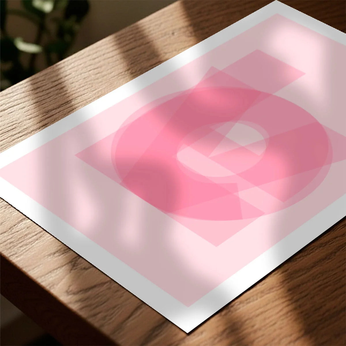 Print laying on table with speckled shade cast across the surface